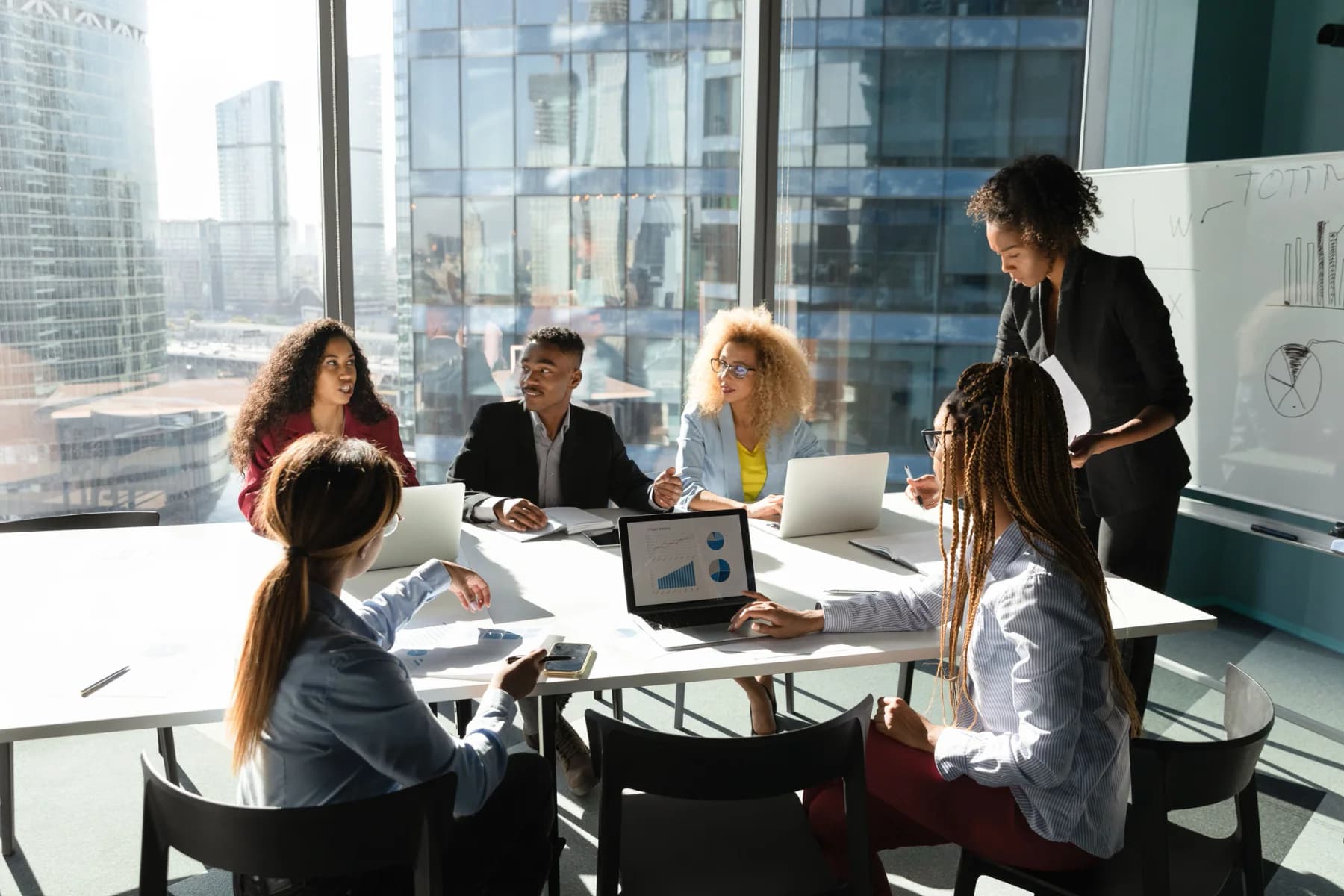 Meeting organizers overseeing a corporate event with laptops and AV equipment