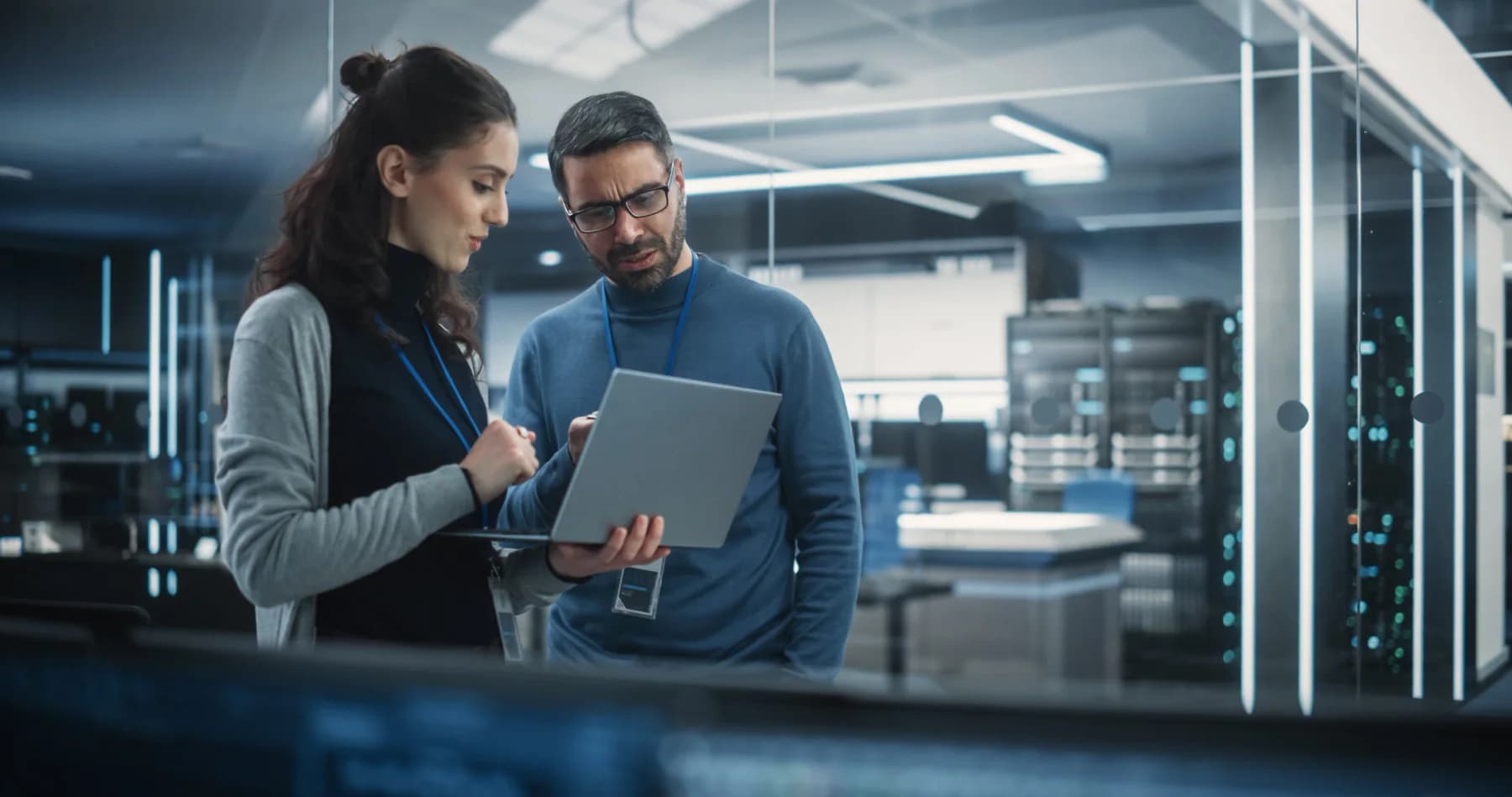 On-site IT technician supporting laptops, monitors, cables, and temporary deployment equipment in a live business or event environment