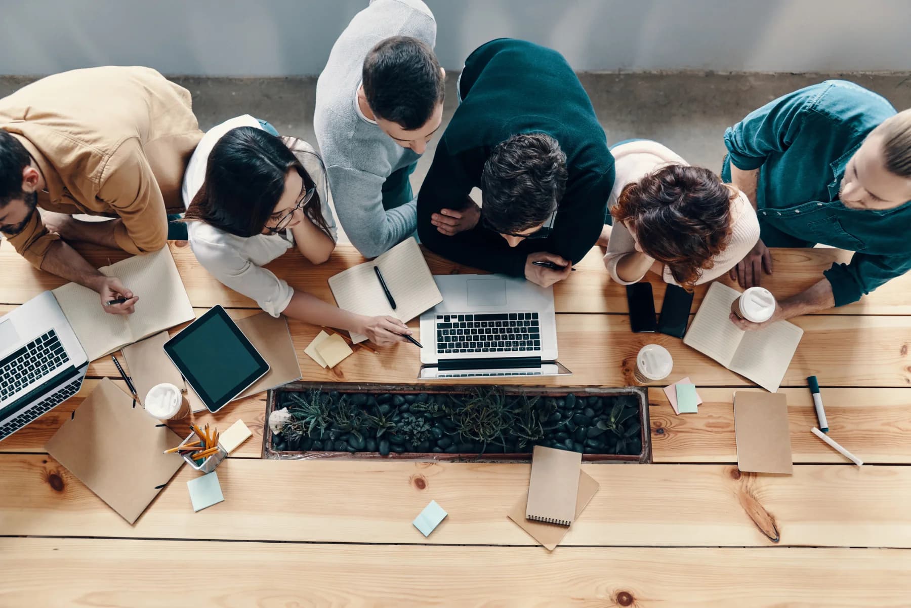 Developer team using rental laptops, tablets, and monitors for software testing and validation