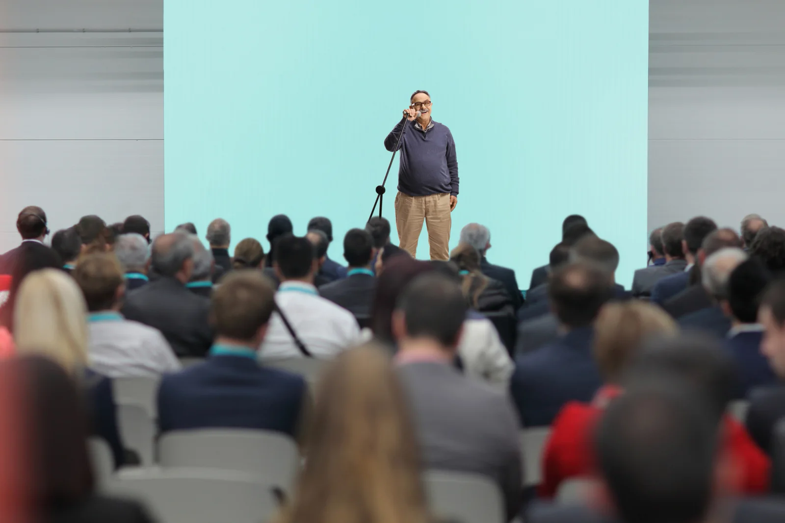 PTZ camera mounted in an event space capturing a business presentation or hybrid conference session