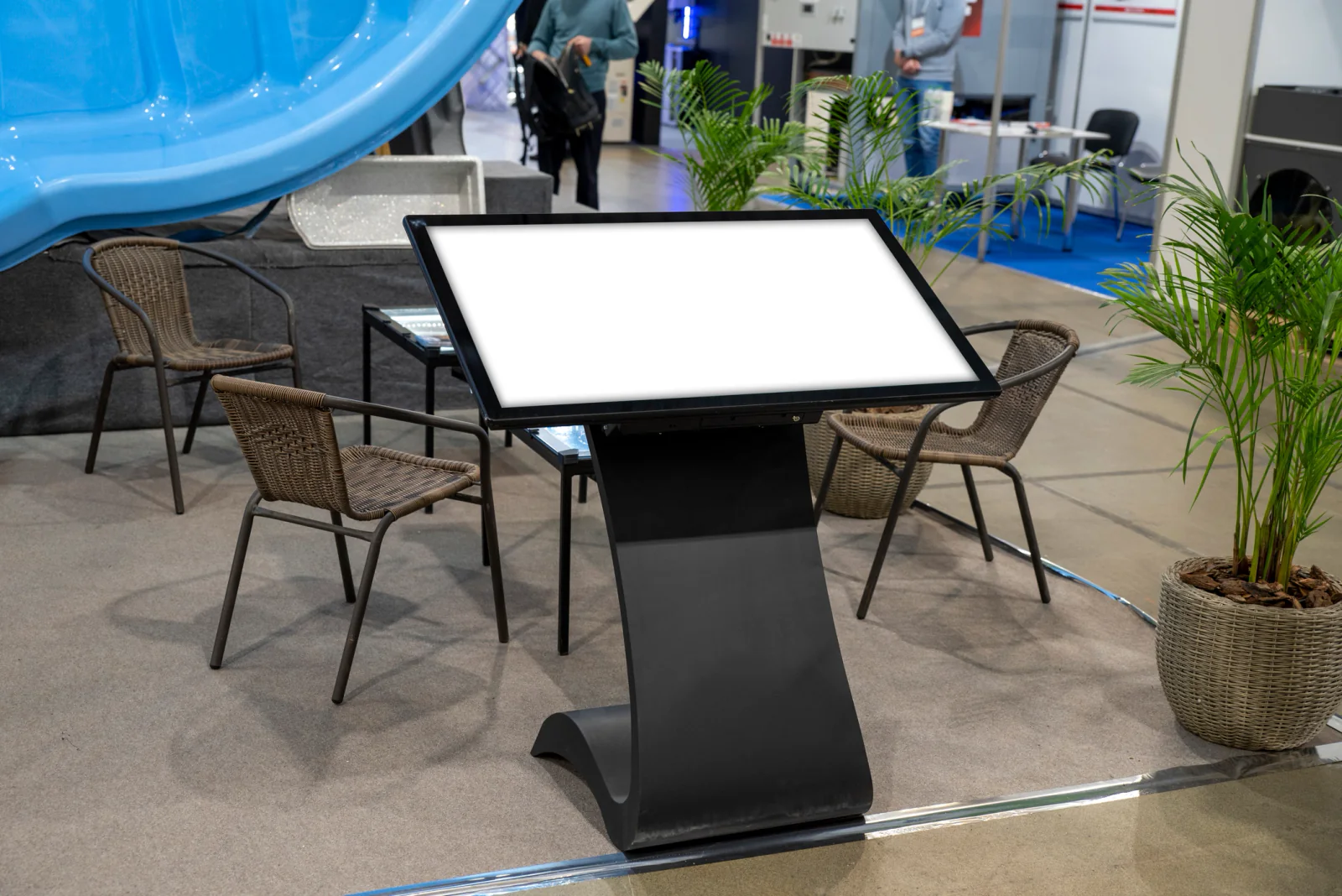 Person interacting with a touchscreen display kiosk at an event or branded activation