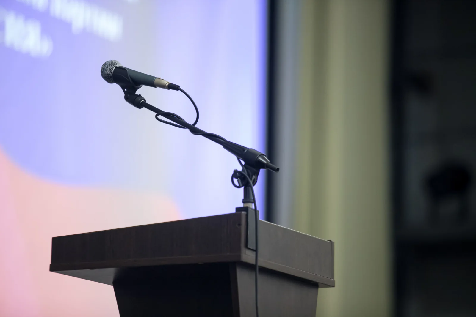 Gooseneck microphone mounted on a podium for formal presentation ceremony or keynote delivery