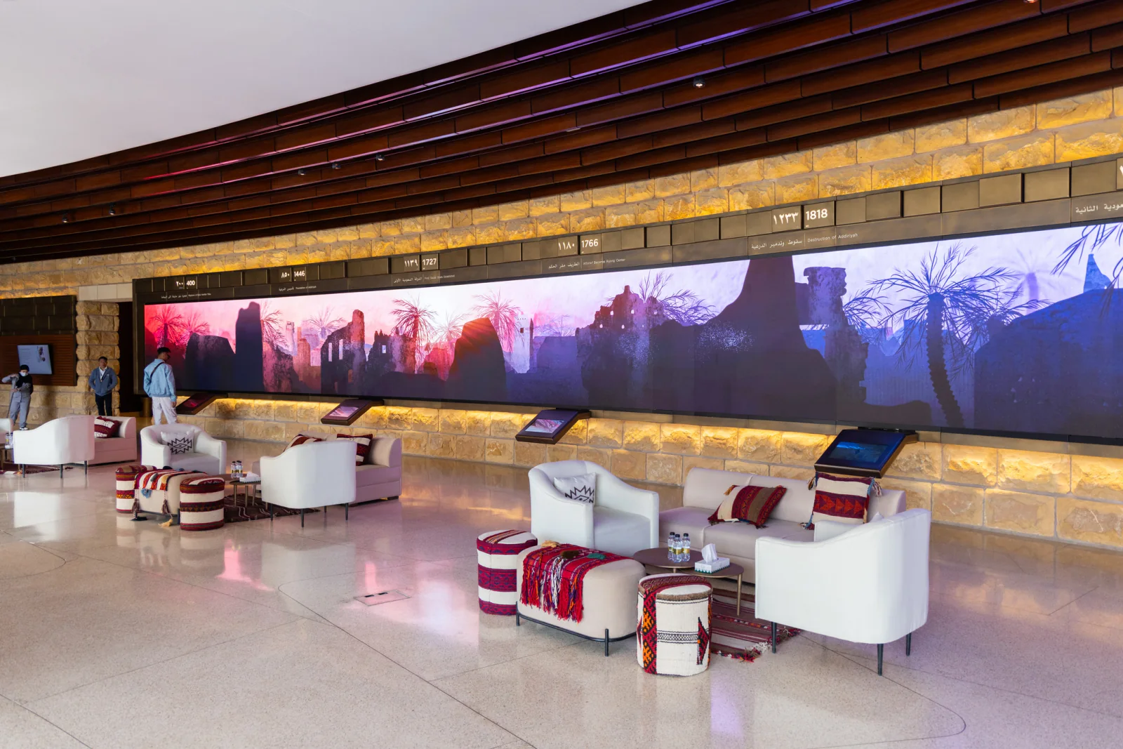Digital sponsor signage displaying partner logos and branded messaging in a busy conference lobby