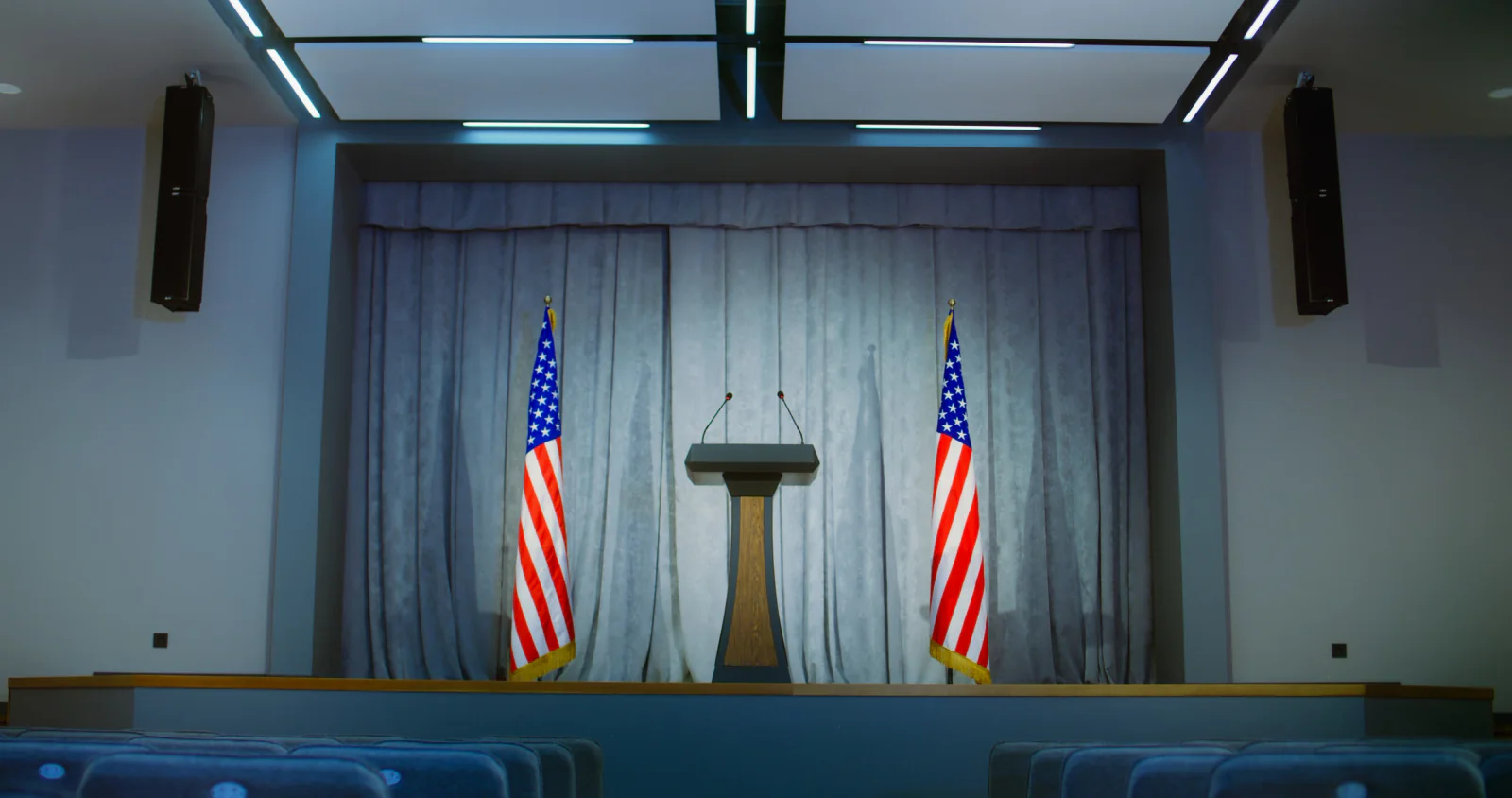Portable stage setup in a ballroom for keynote presentations panel discussions and formal event programming