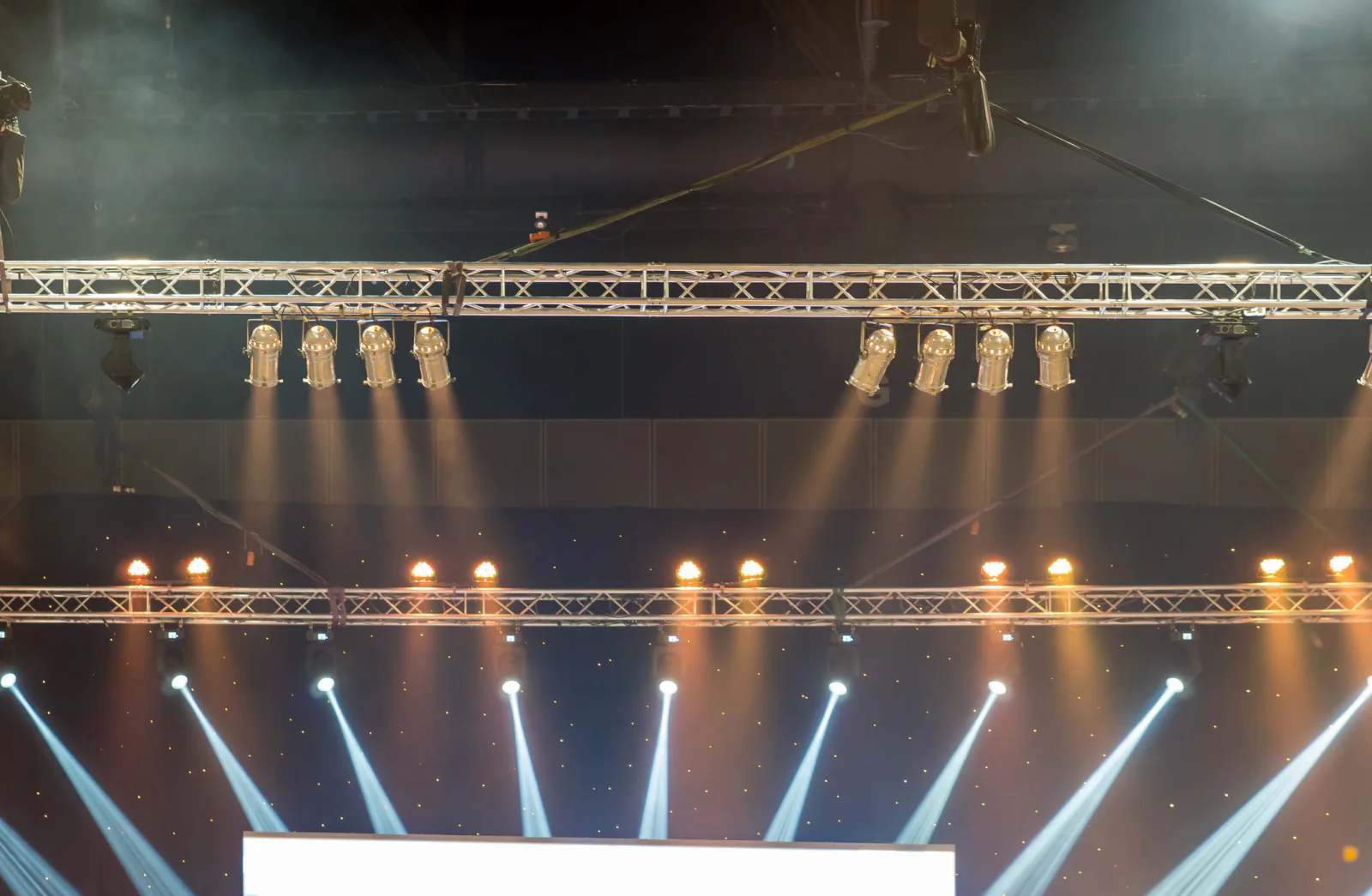 Keynote speaker on a stage with lighting in a ballroom or business event environment