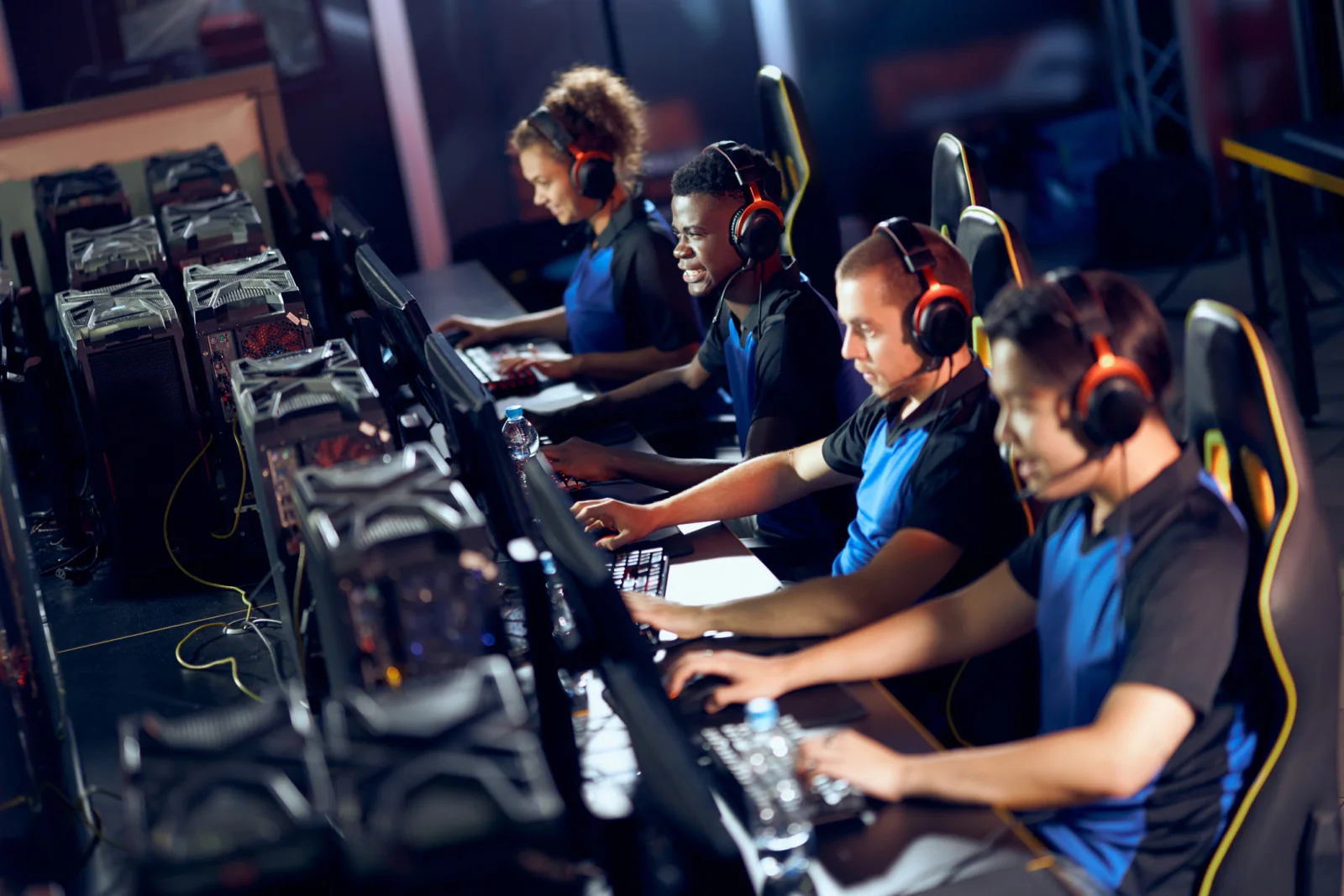 Rows of gaming desktop stations set up for an esports tournament with monitors and peripherals