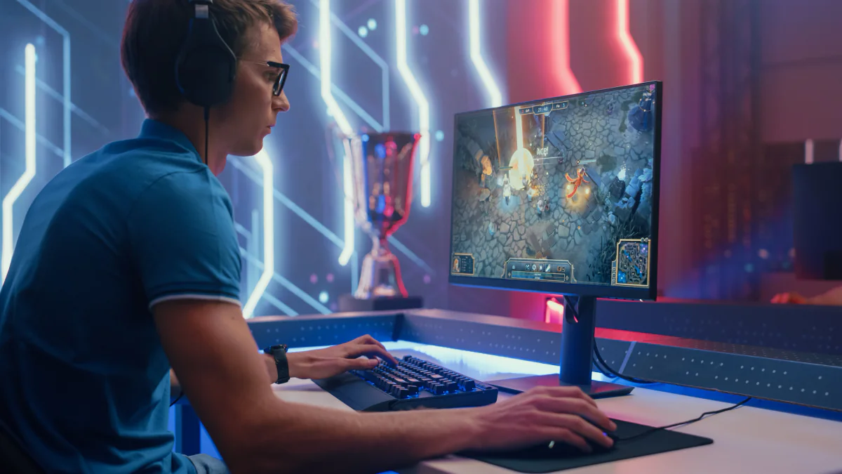 Featured esports tournament setup with rows of gaming desktops, monitors, keyboards, and mice