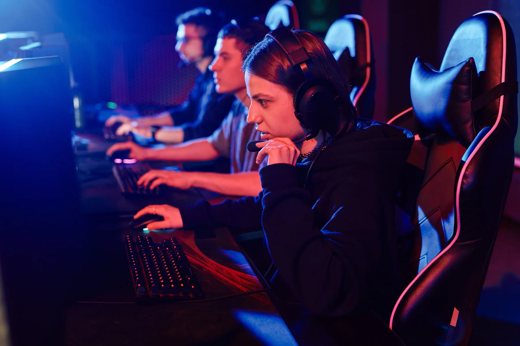 LAN esports tournament with competitors seated at standardized gaming PC stations in a large event hall
