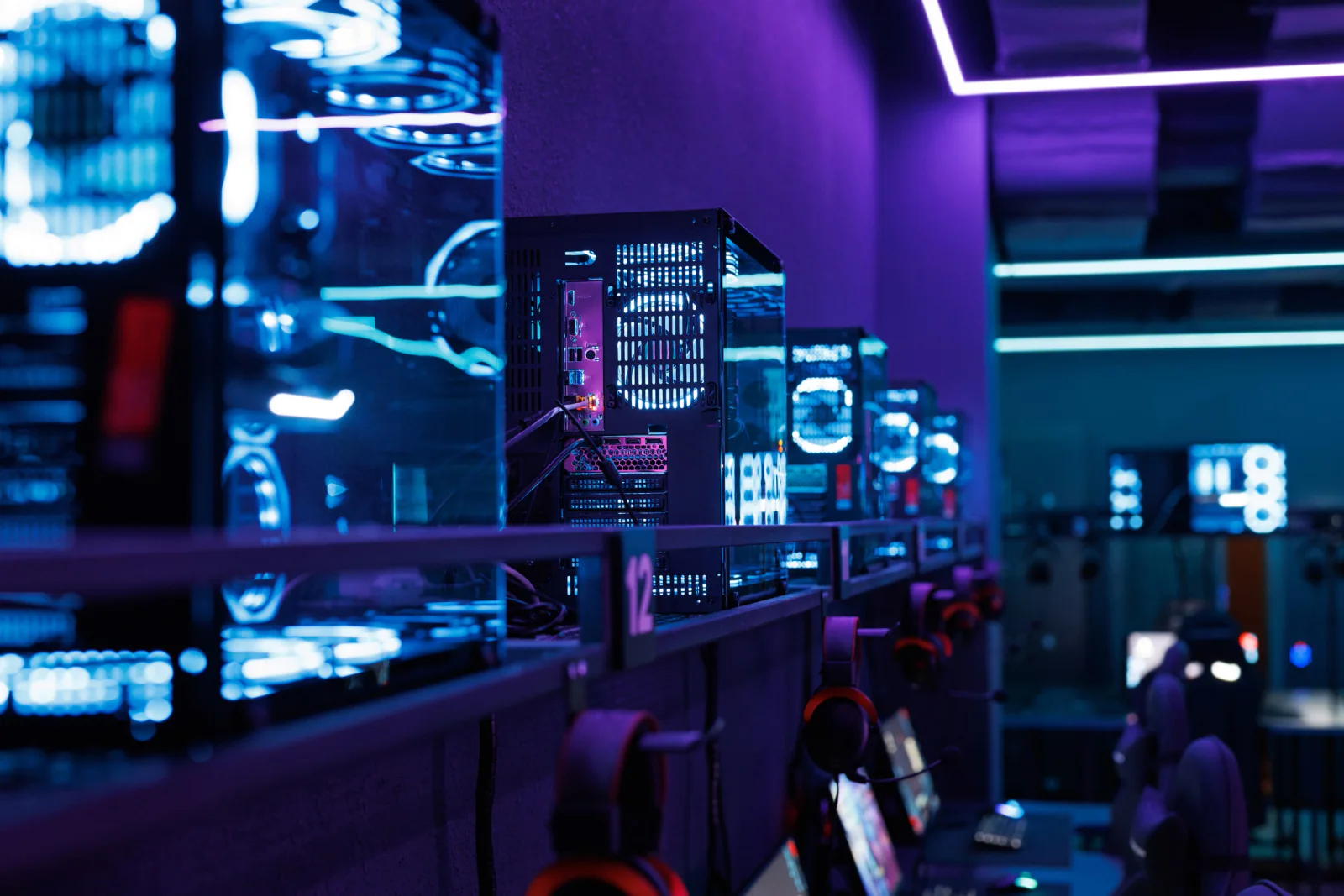 Esports tournament with gaming desktop stations, monitors, peripherals, and players at a live event