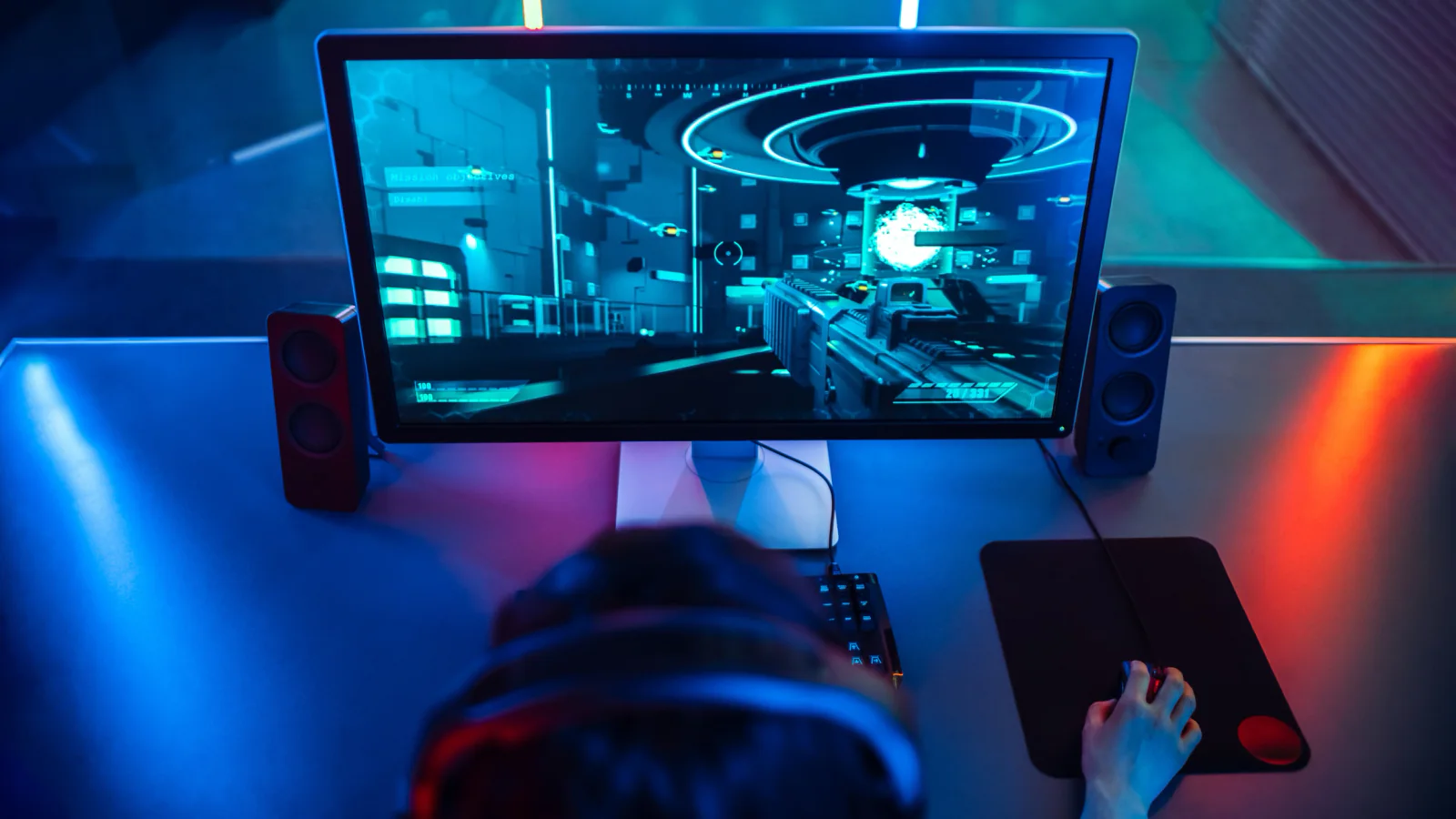 Esports event with rows of gaming stations using matching monitors for competitive play