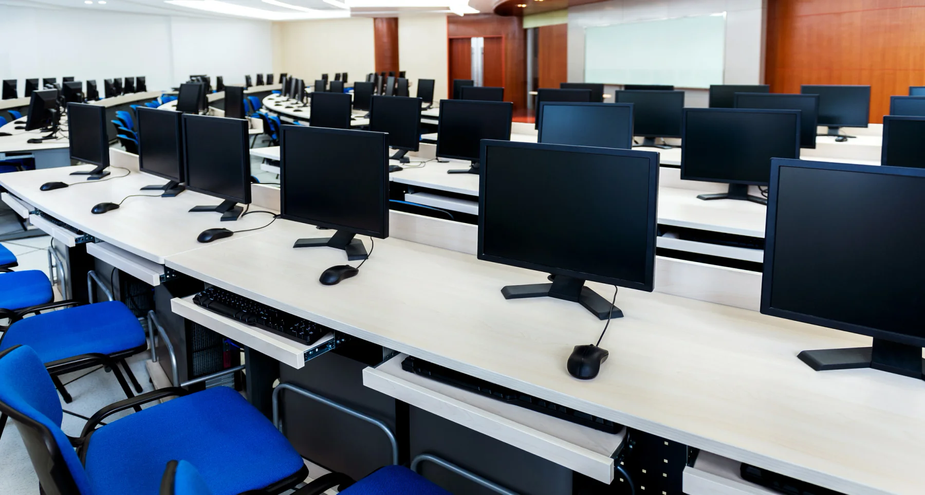 Standardized classroom laptops prepared with matching software and settings for training, exams, or certification testing