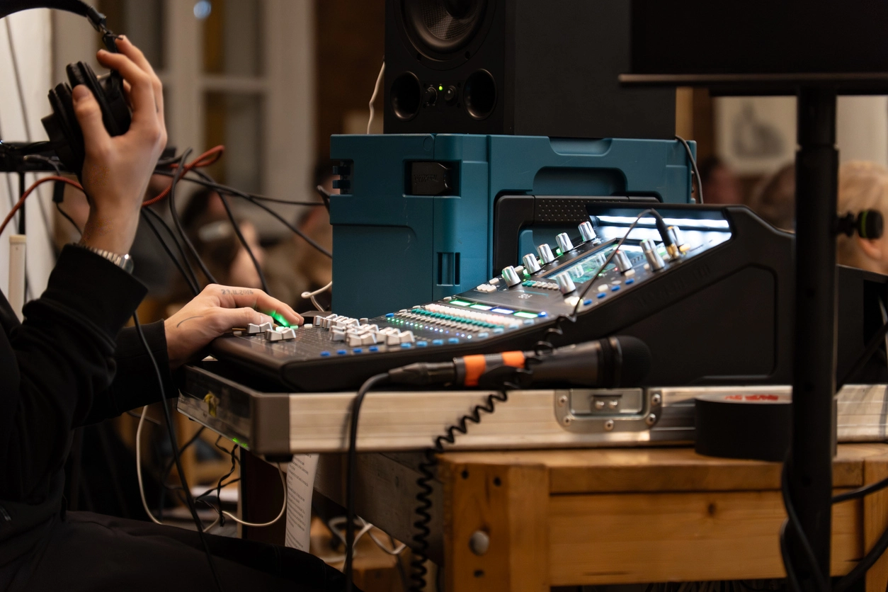 Event technician setting up audio visual and interpretation equipment before a conference