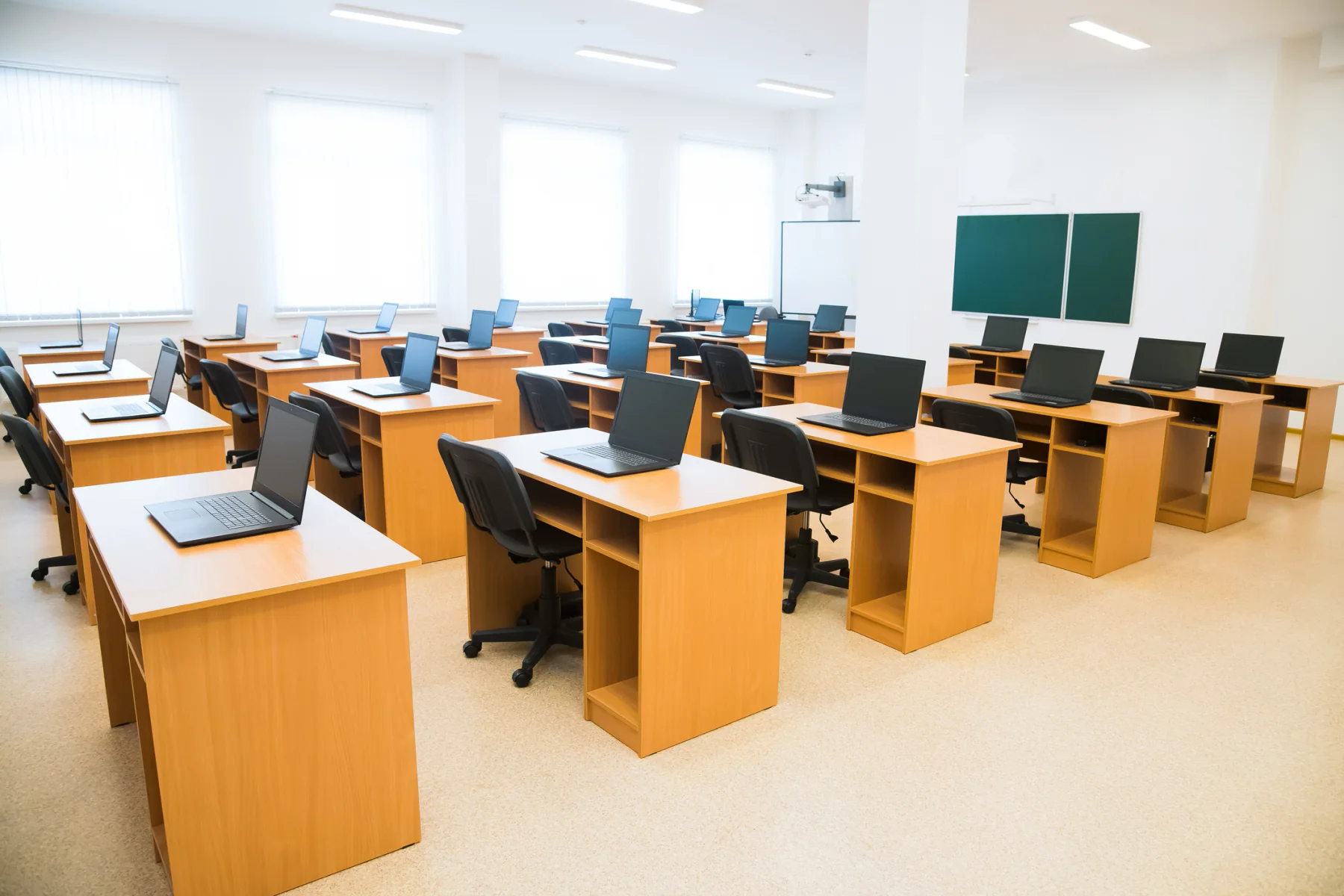 Classroom training and testing environment with rows of laptops prepared for browser based assessment workflows