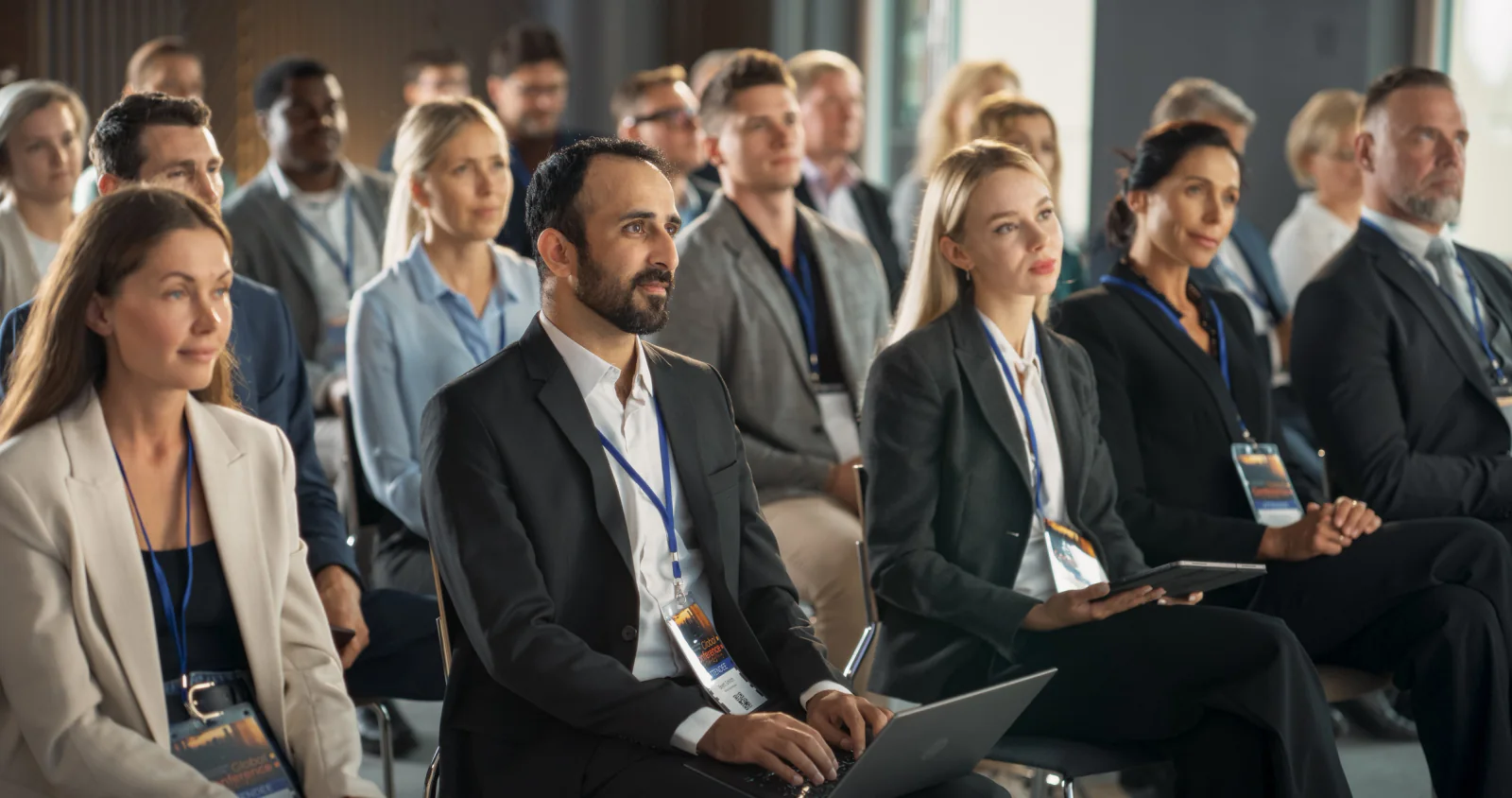 Large multi-room conference deployment with keynote stage, breakout rooms, registration desks, and rental technology across the event venue