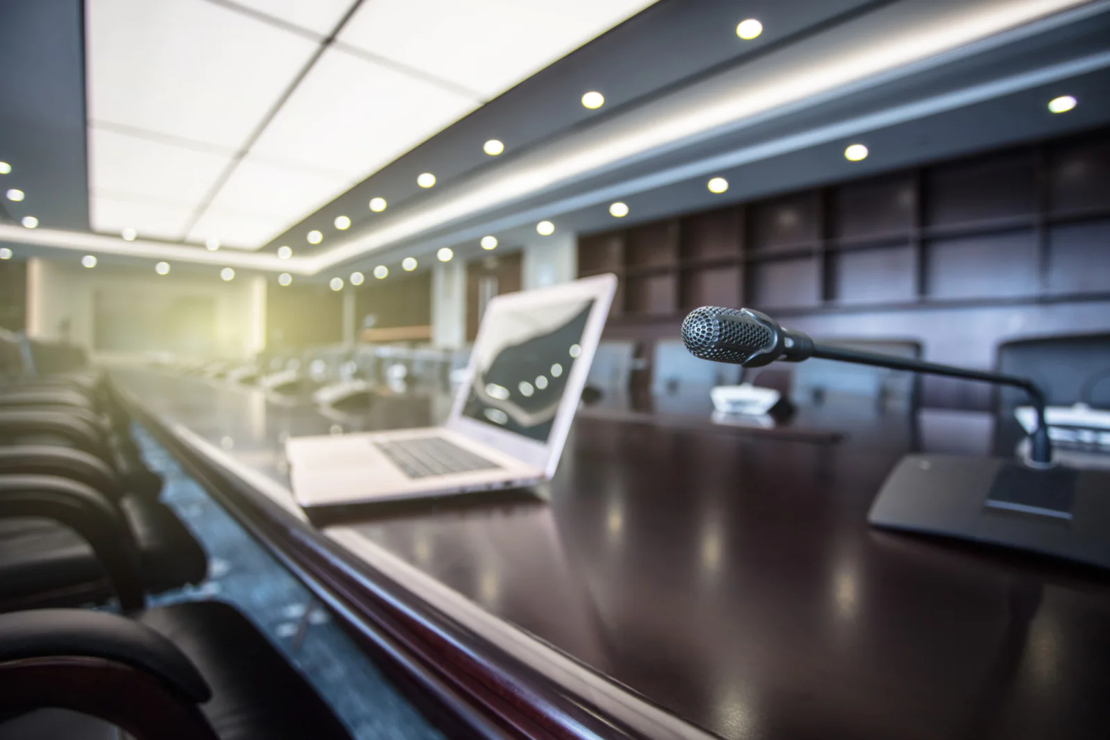 Executive boardroom meeting with rental large display, presenter laptop, and polished conference room presentation setup