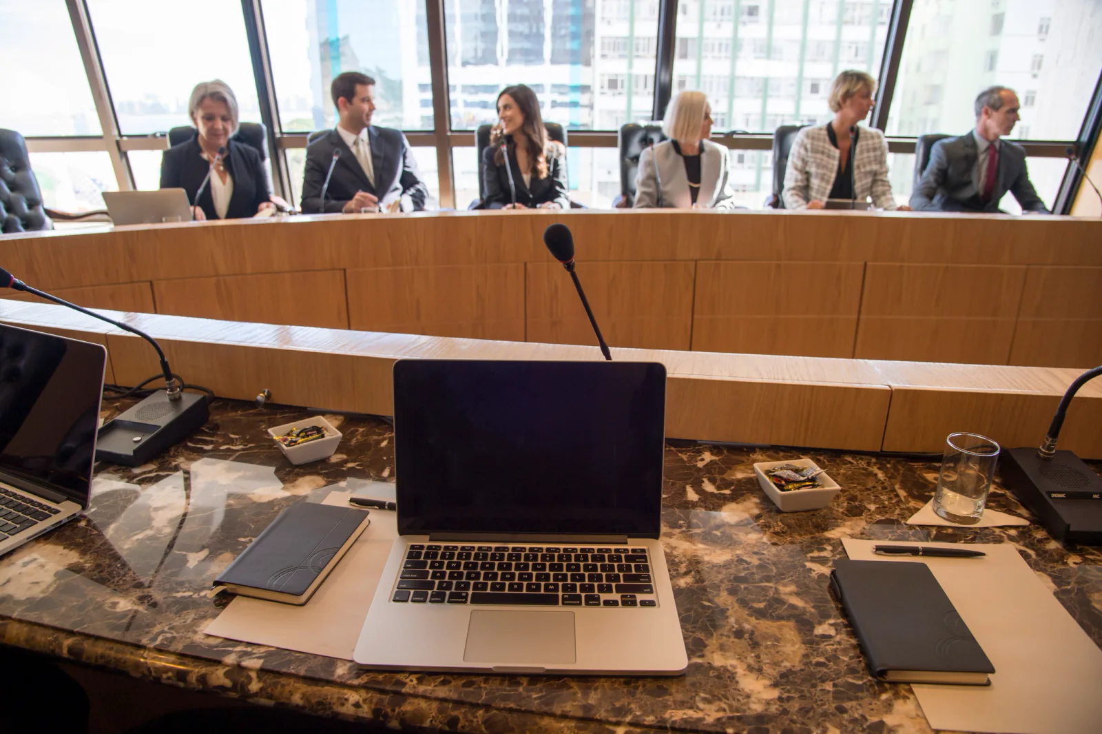 Executive leadership meeting in a boardroom with rental display, presenter laptop, and polished presentation technology setup