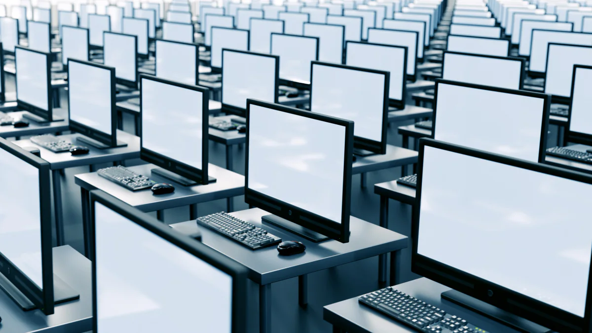 Large scalable testing deployment with rows of rental laptops and spare devices ready for a high volume exam or training operation