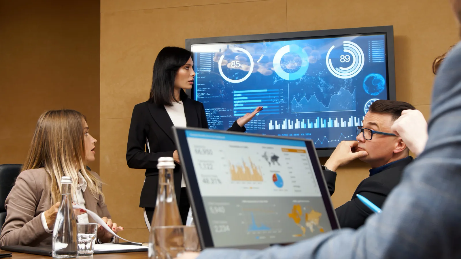 Launch command center with marketers reviewing live dashboards on large monitors and coordinating campaign activity