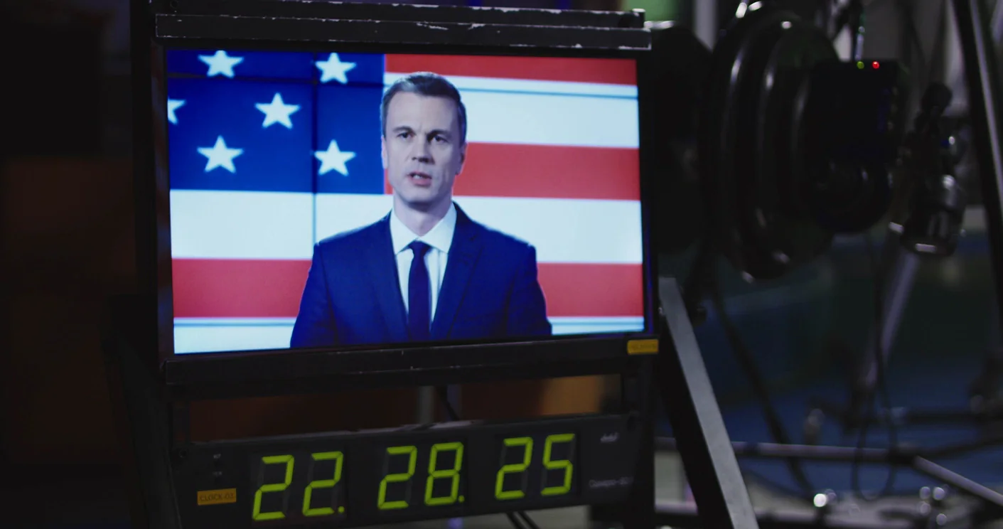 Election night coverage room with multiple screens showing live results and maps