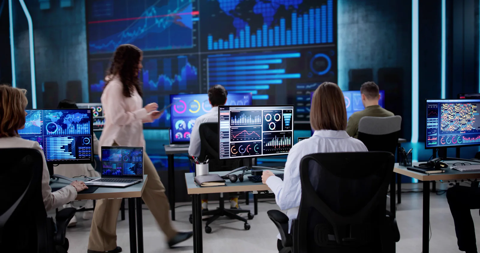 Broadcast production workspace supporting overflow programming with editing stations, monitors, and operations staff