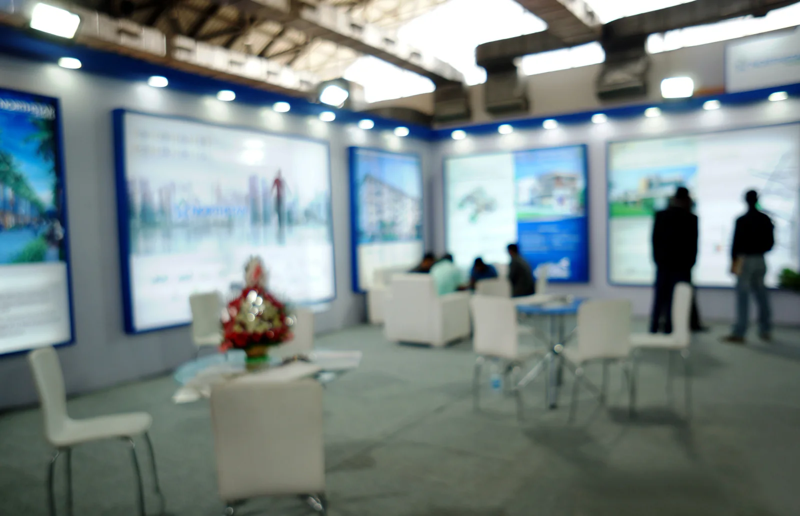Convention center exhibit floor with large display walls and expo booths for sponsors and exhibitors