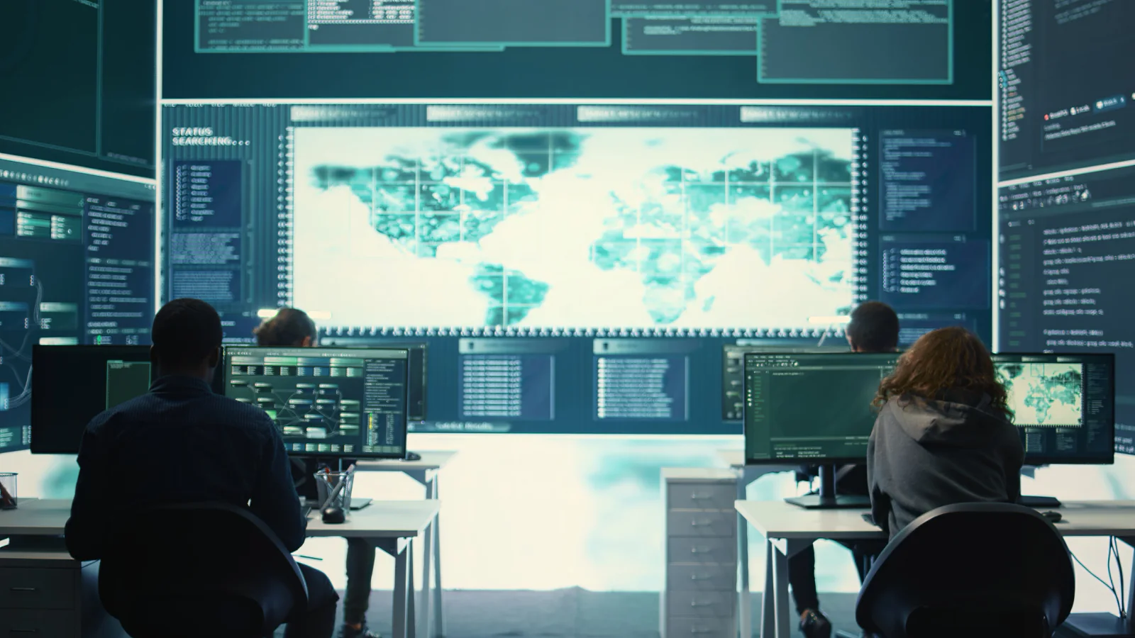 Government field staff using tablets and laptops in a temporary mobile operations space