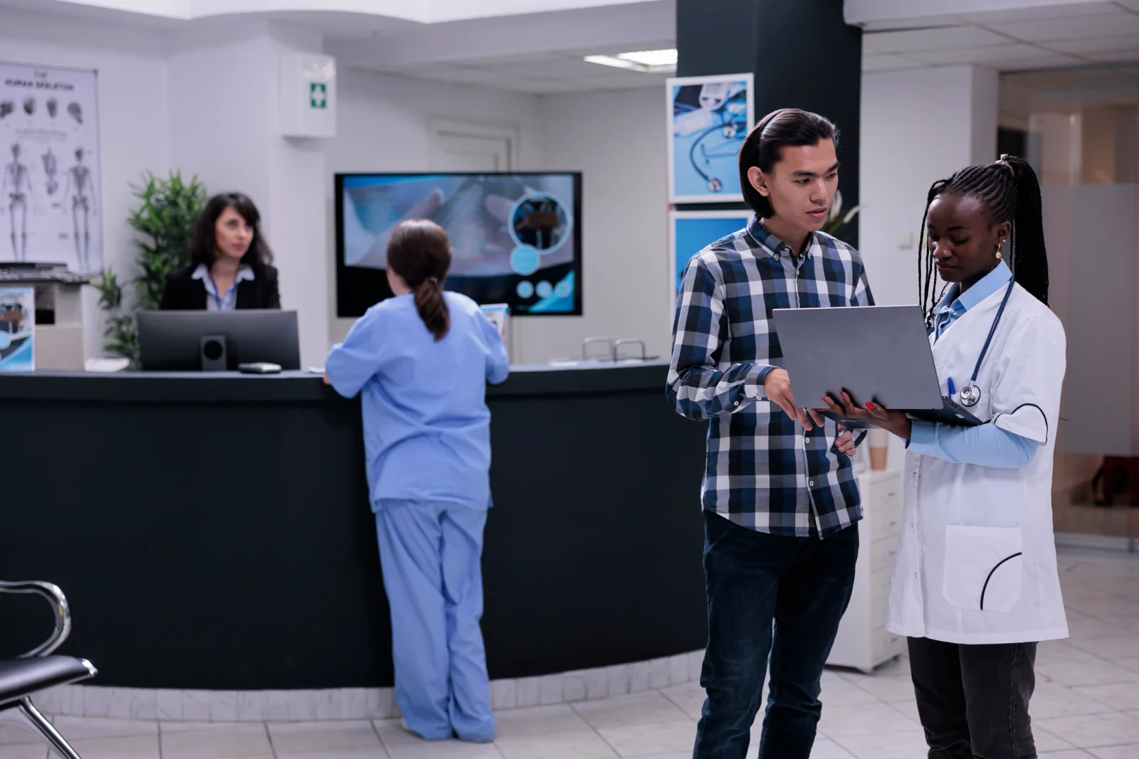 Telehealth hub with clinicians using workstations and large displays for remote patient monitoring