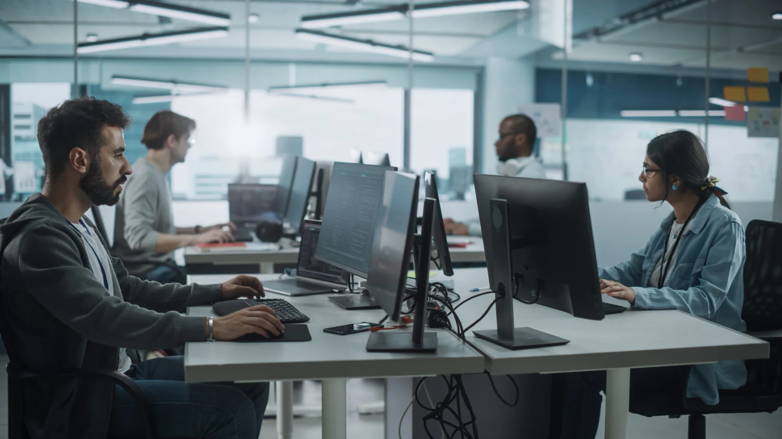 Researchers collaborating around workstations and displays in a university lab