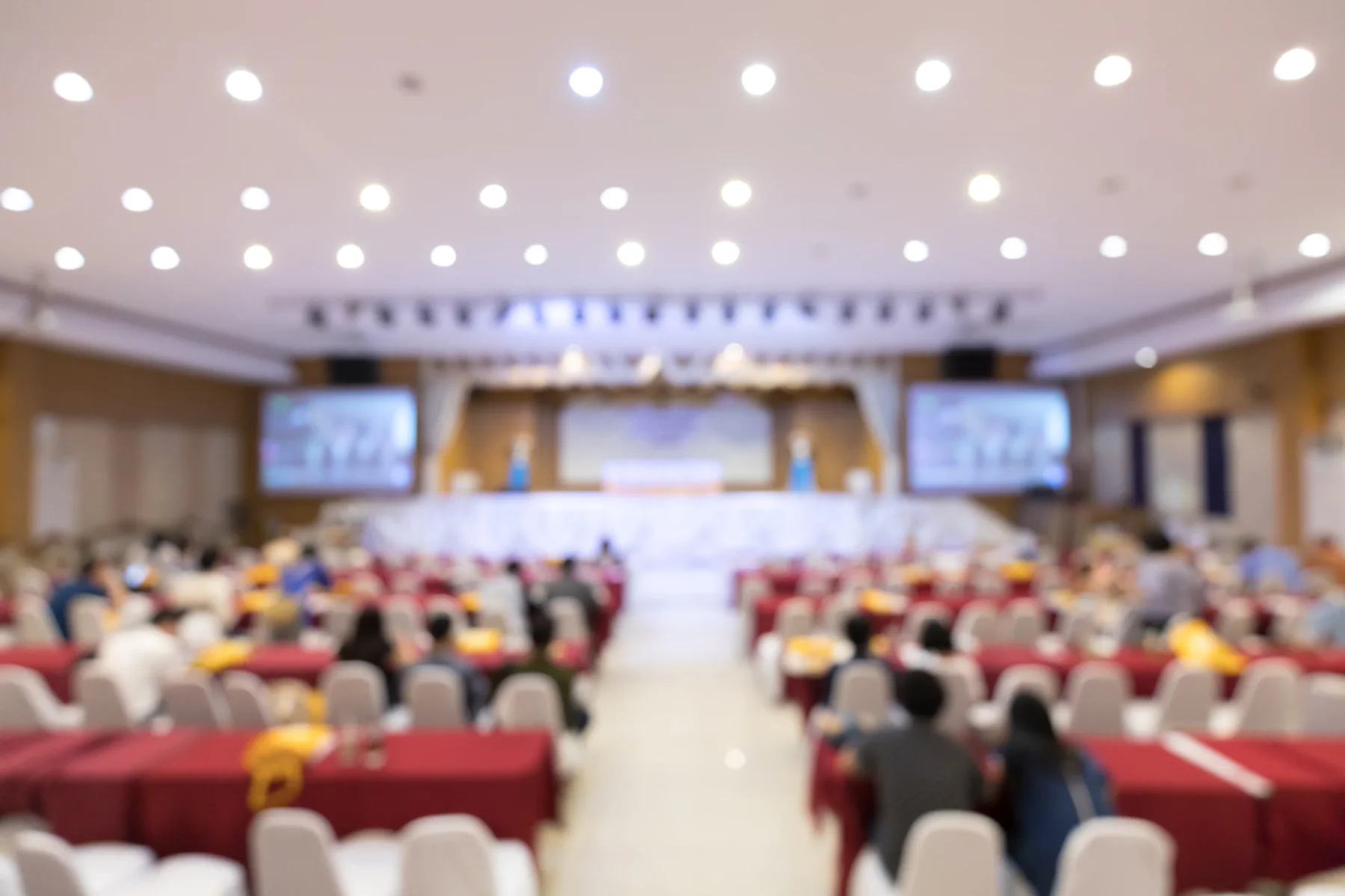 Hotel ballroom setup with AV equipment and screens for an event