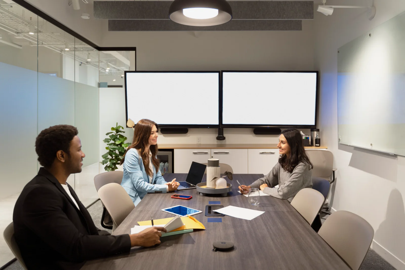 Multi-room conference setup with breakout sessions, presentation screens, microphones, and organized meeting technology across several rooms