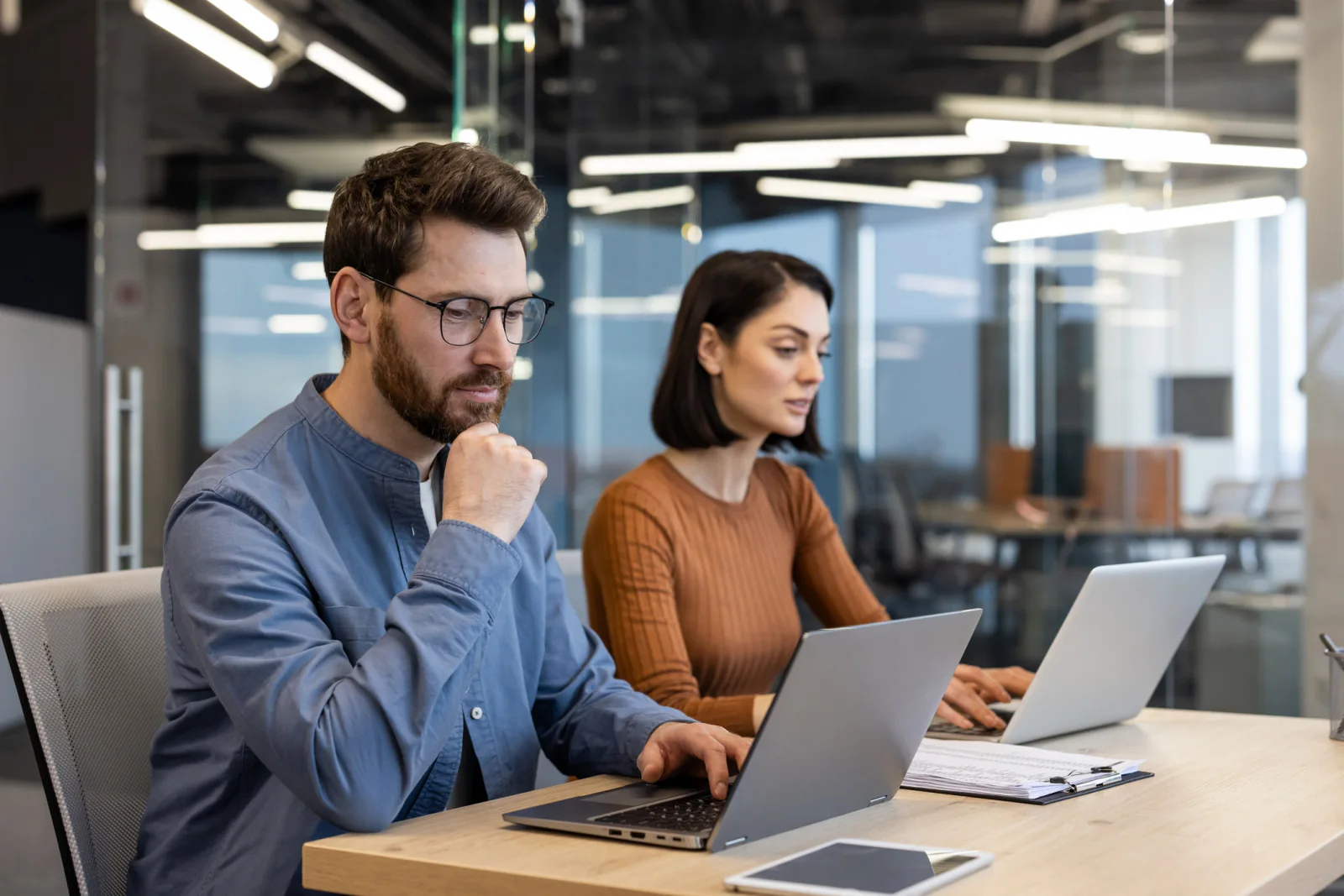 Small business office with a growing team working on laptops and monitors