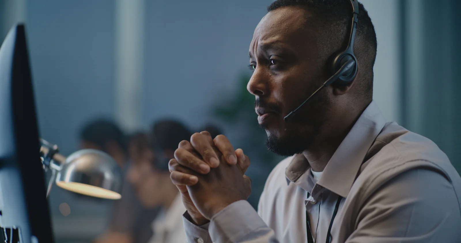 Incident response room with staff monitoring large screens and coordinating restoration