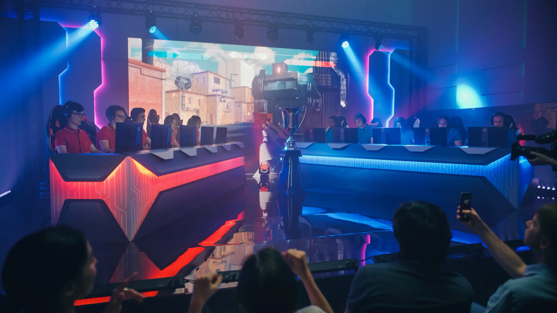 Esports event stage with players and large screens showing gameplay
