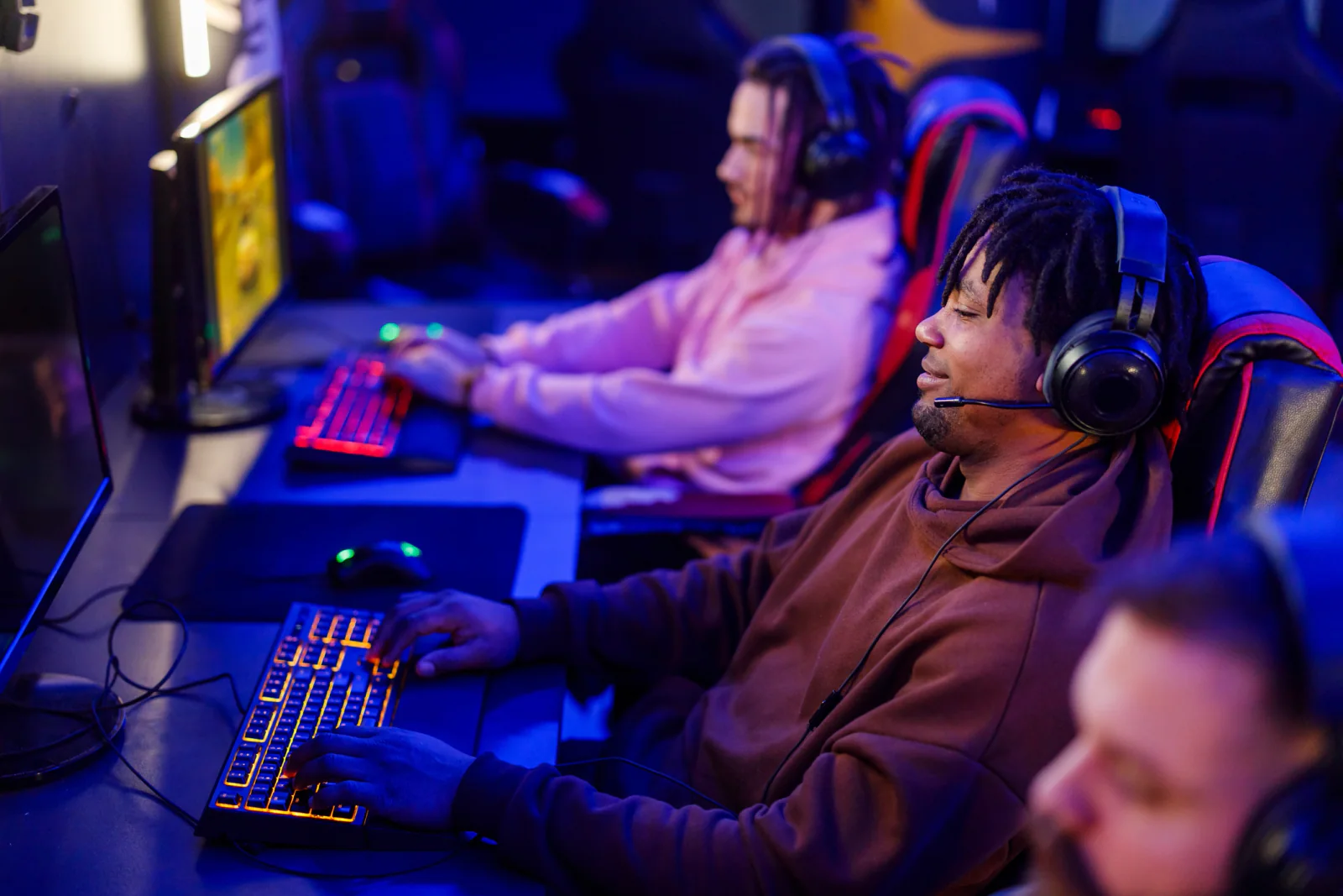 LAN event with players in rows using gaming PCs and monitors