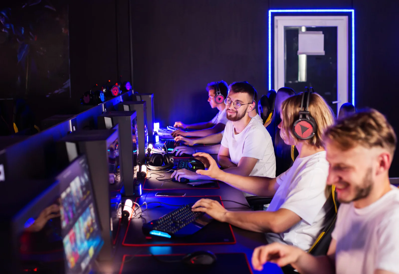 Game testers at workstations playing and logging issues on PCs