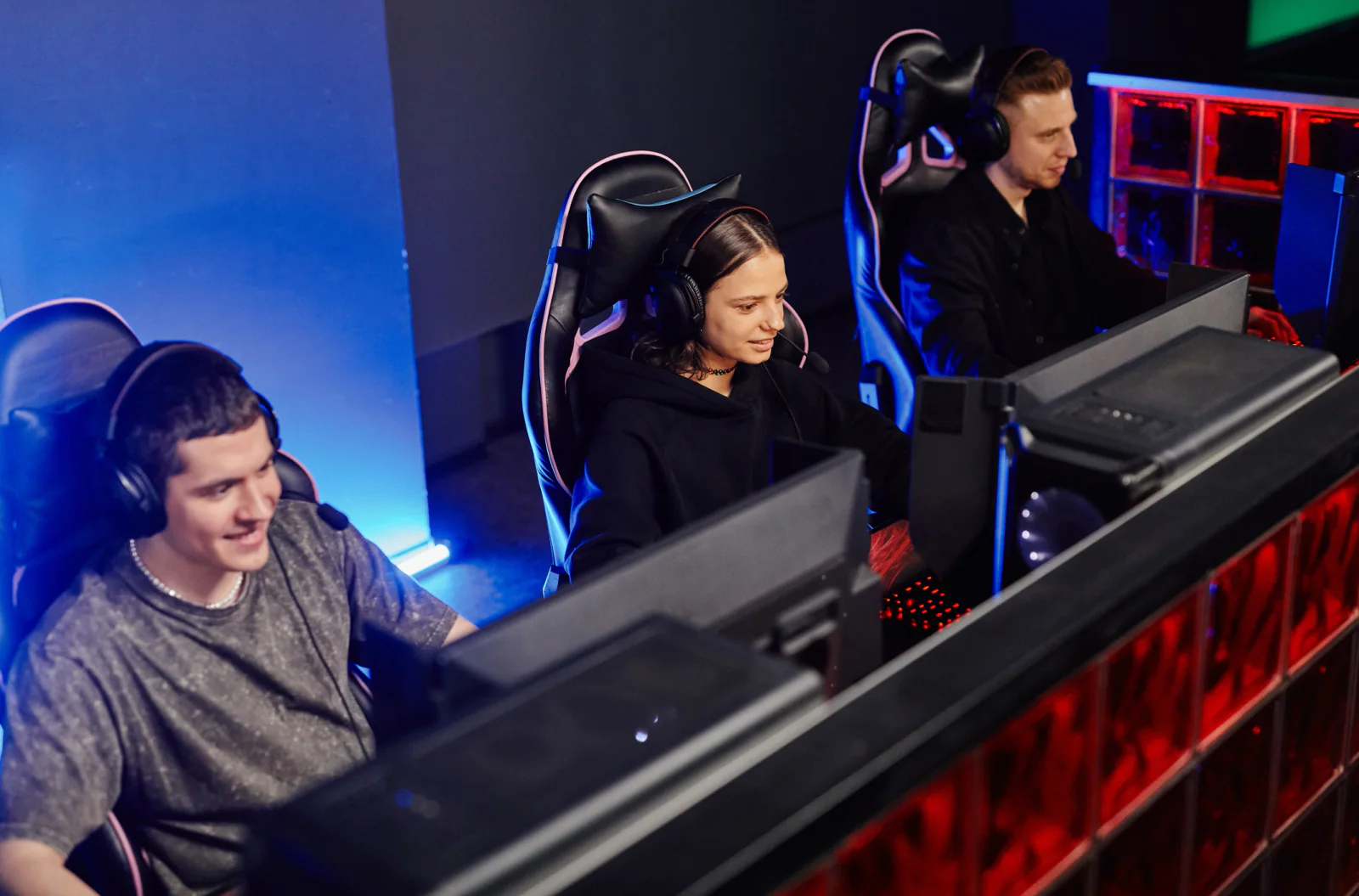 Esports broadcast control room with production workstations, multiview monitors, operators, and streaming support equipment