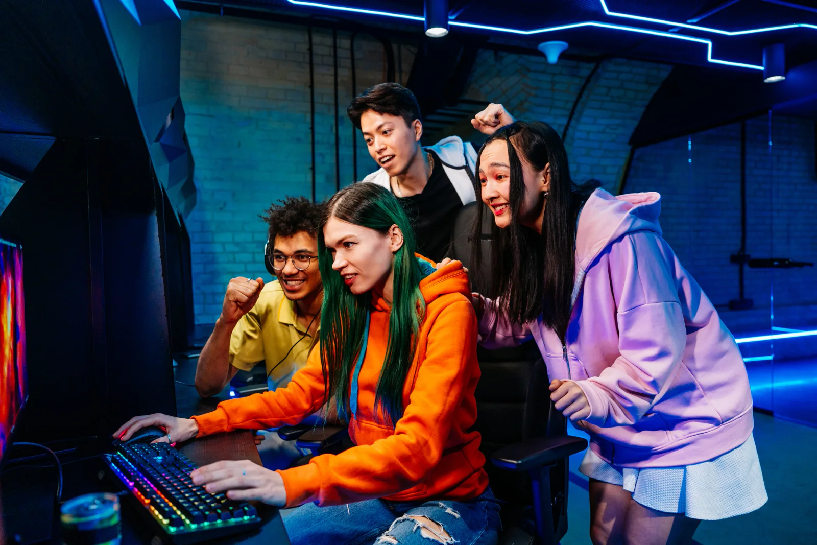 Gaming fan zone with branded demo stations, consoles, gaming PCs, digital signage, and attendees trying interactive experiences