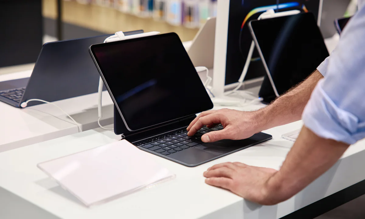 Salesperson using a Microsoft Surface device with a client during a field presentation