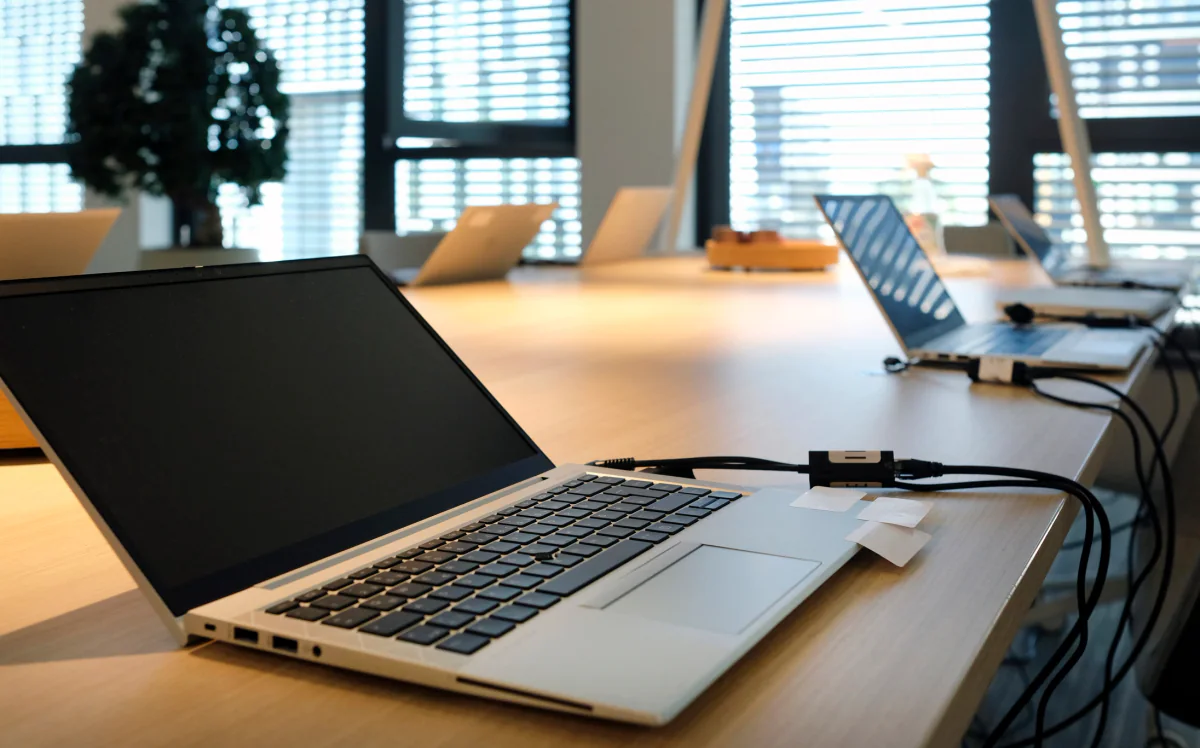 Standard business Windows laptop rentals arranged on desks for office work, registration, and training environments