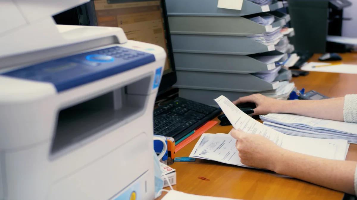 Busy office with multiple printers handling heavy short-term printing workloads