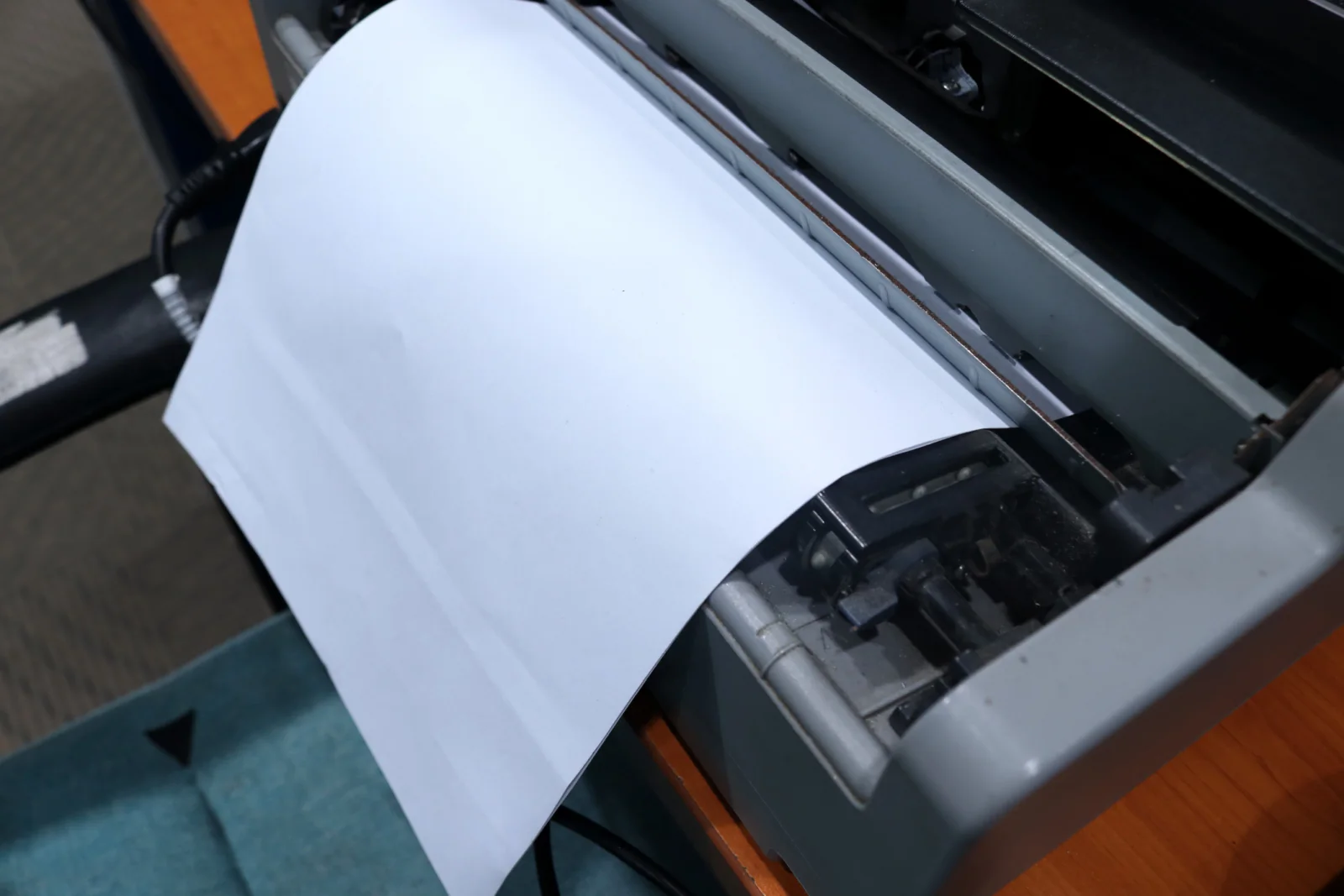 Large-format plotter printing an architectural blueprint for engineering and design work