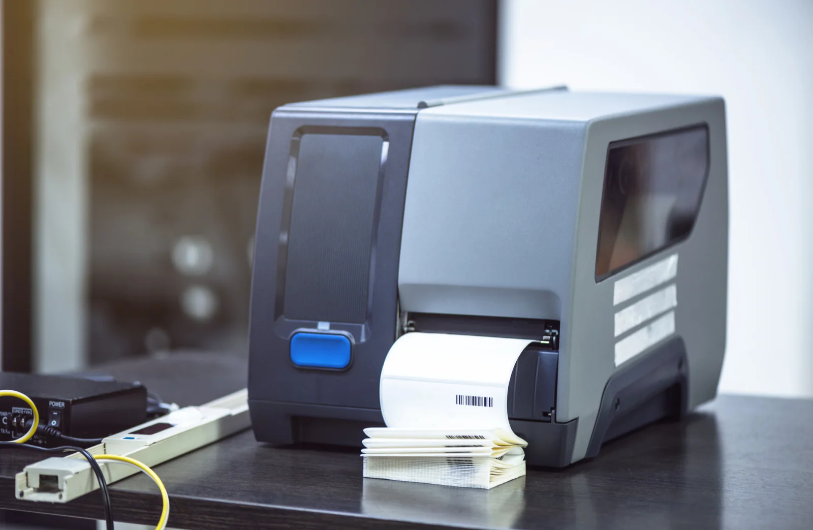 RFID label printer with labeled tags in the output tray for tracking and asset management workflows