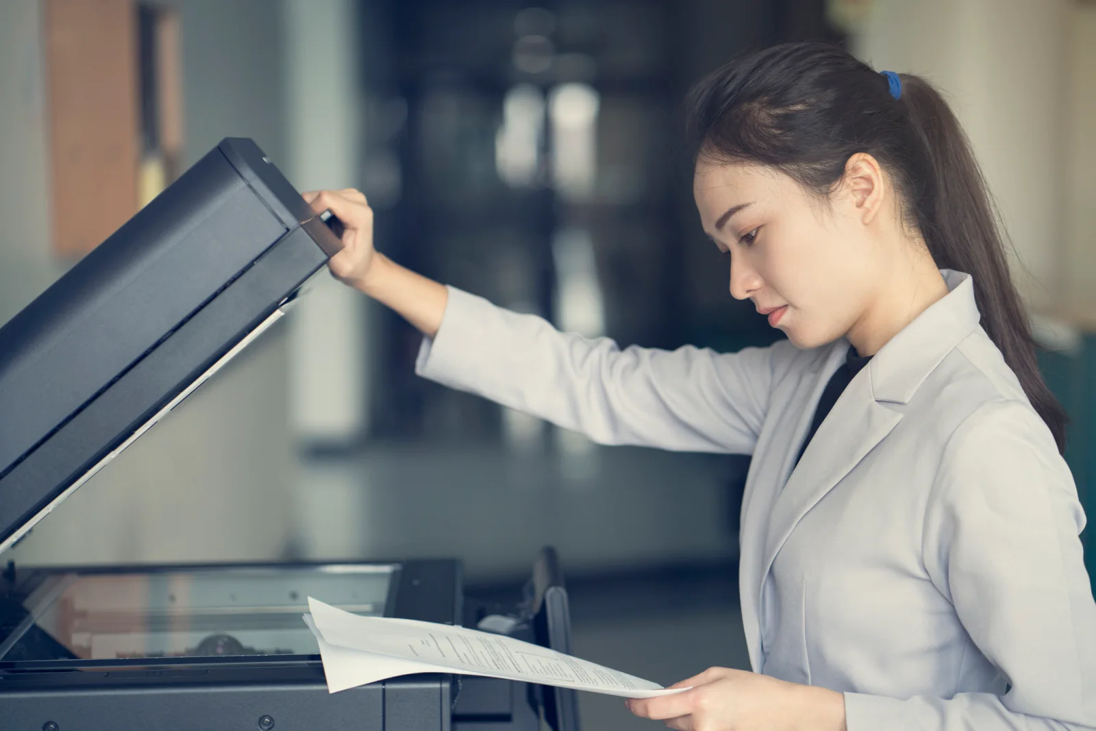 Office worker scanning stacks of documents for an audit, compliance review, or legal records project