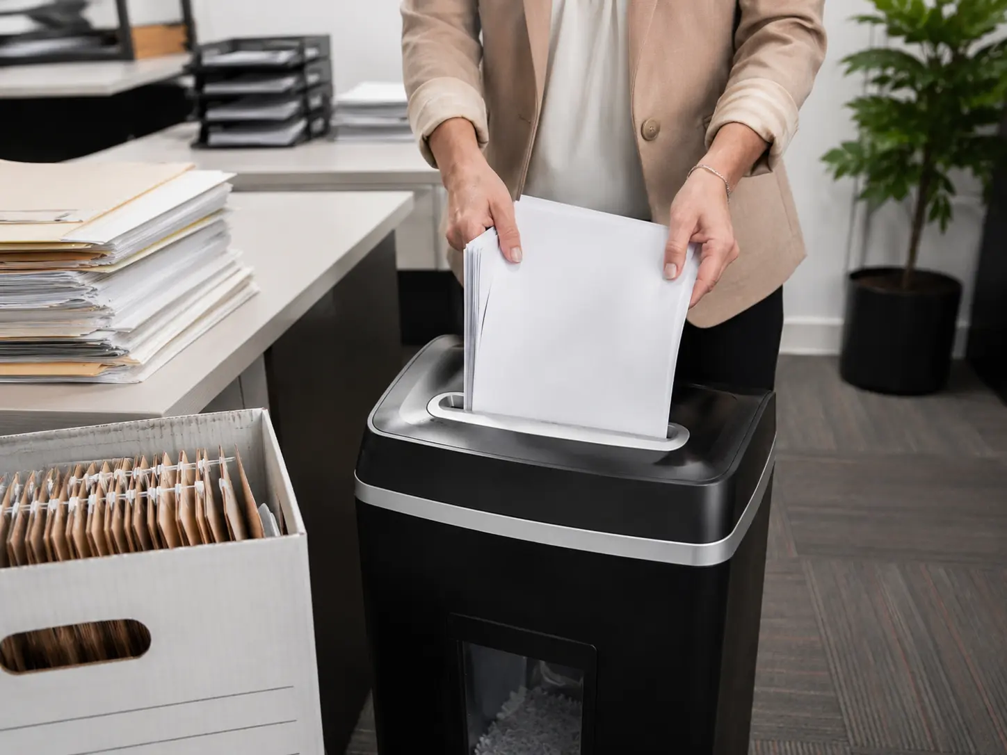 Office being packed up with a shredder nearby for secure document disposal during a move