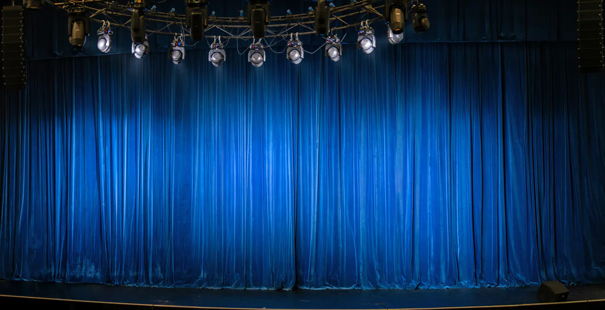 Pipe and drape stage backdrop setup for keynote presentations sponsor branding room separation and temporary event spaces