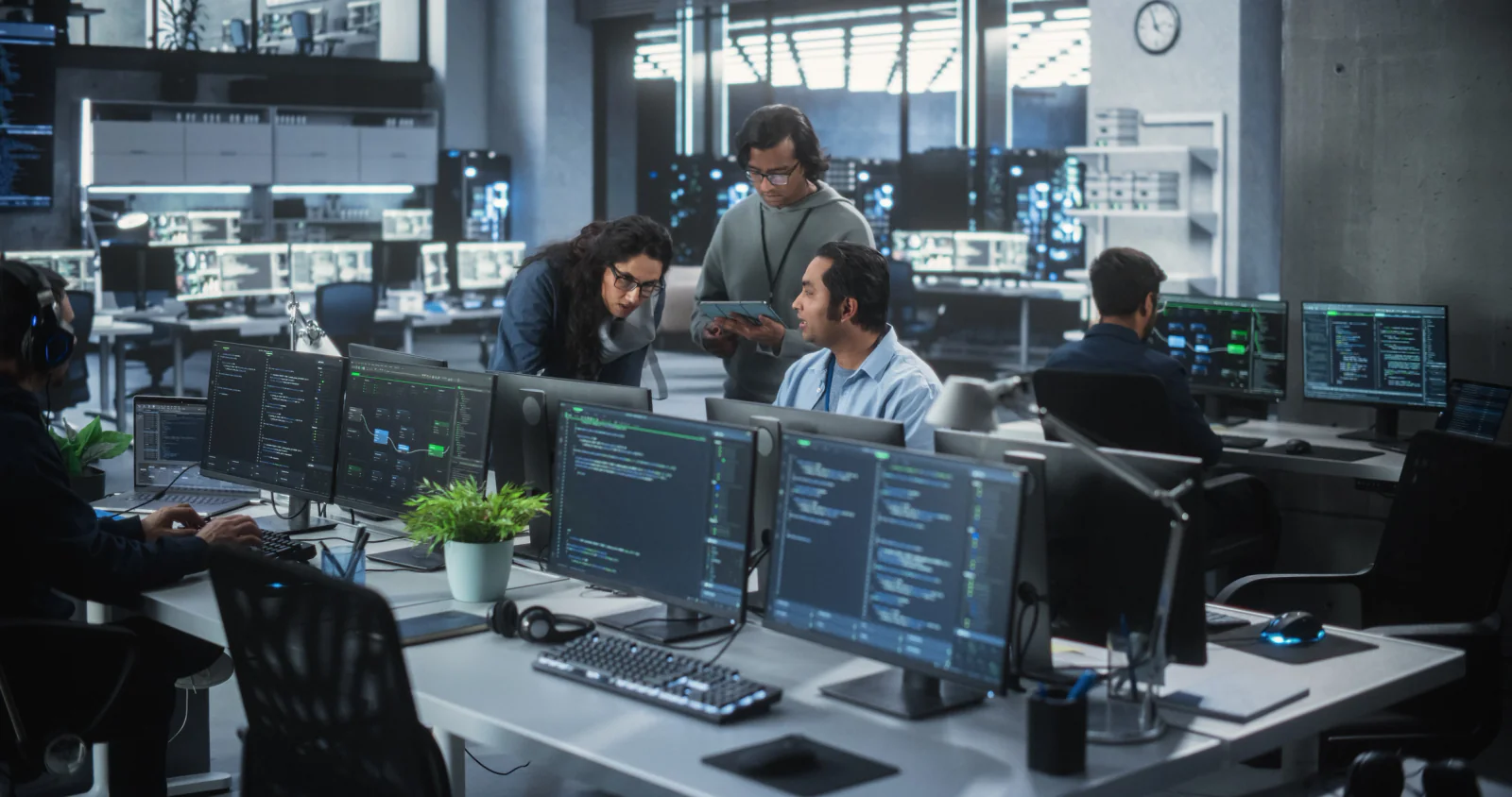 Quality assurance team validating software across multiple rental laptops and monitors before release
