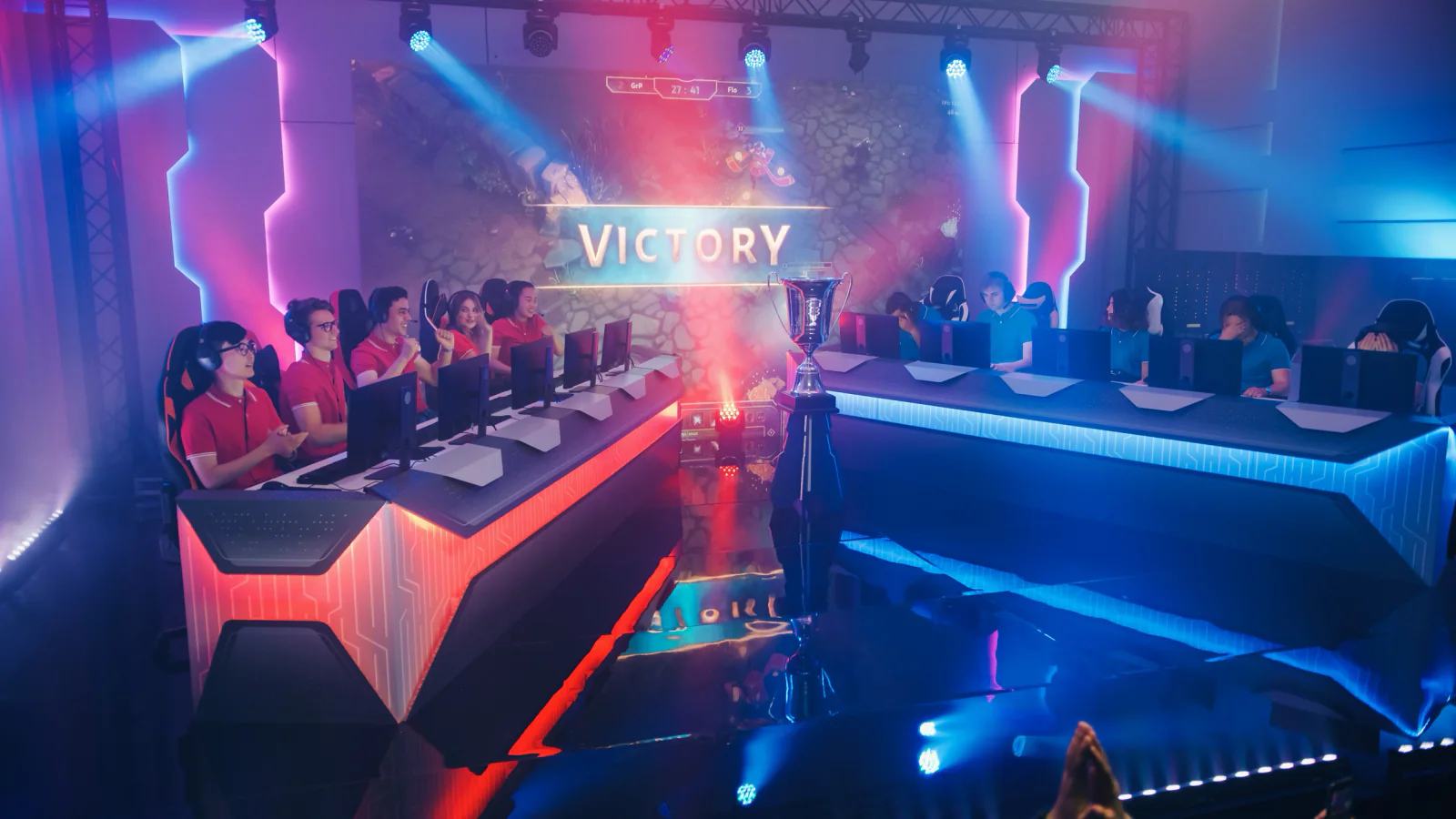 Temporary esports arena setup inside a ballroom or event venue with rows of gaming stations and large display screens
