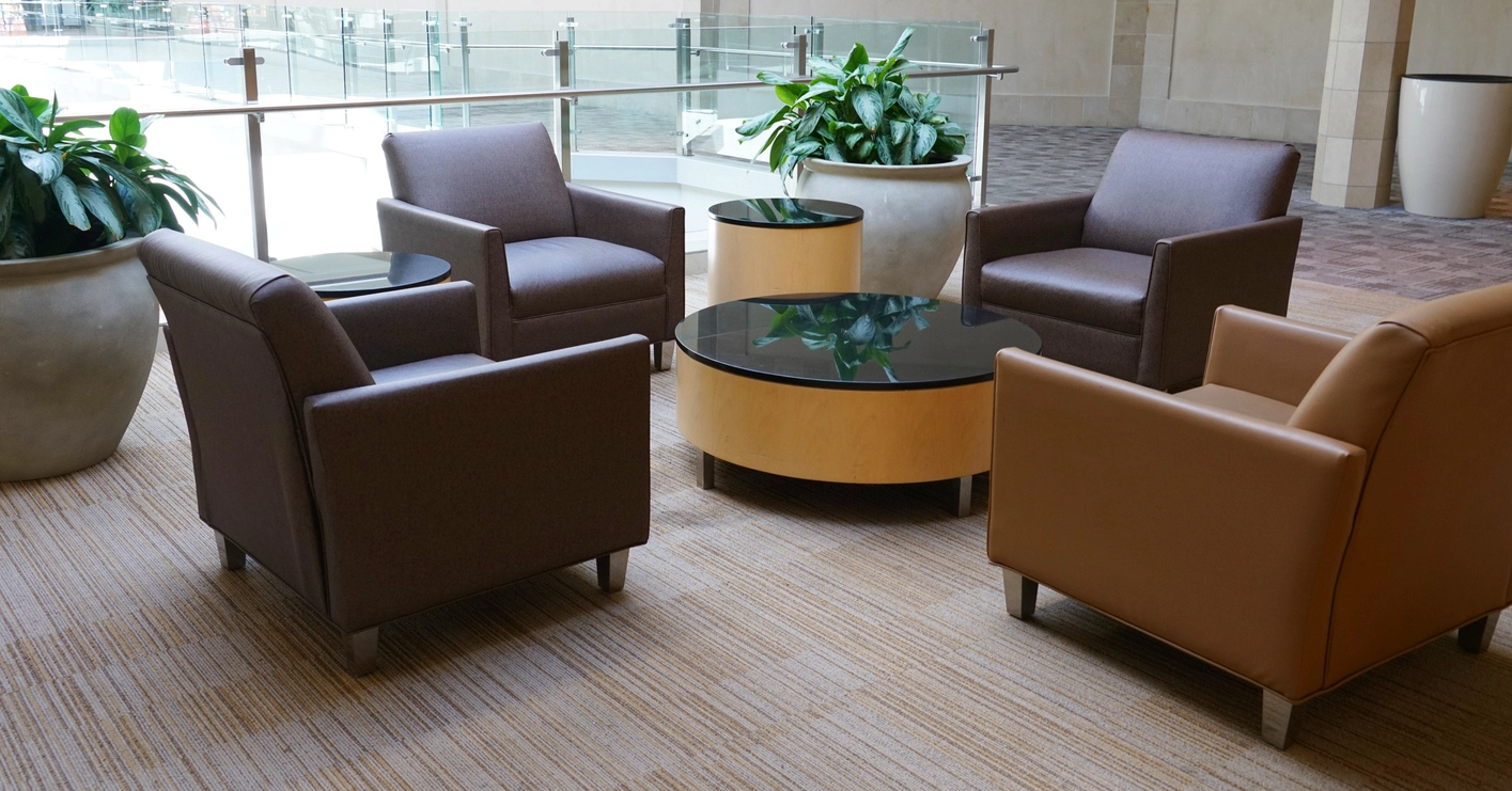 Modern corporate event lounge furniture with tables seating and branded display areas