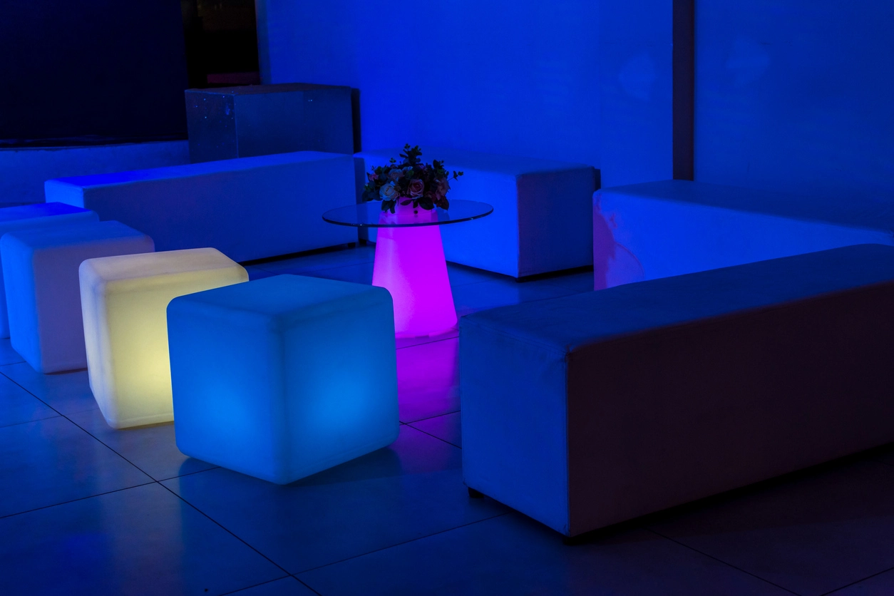 Illuminated LED furniture pieces in a branded corporate event lounge
