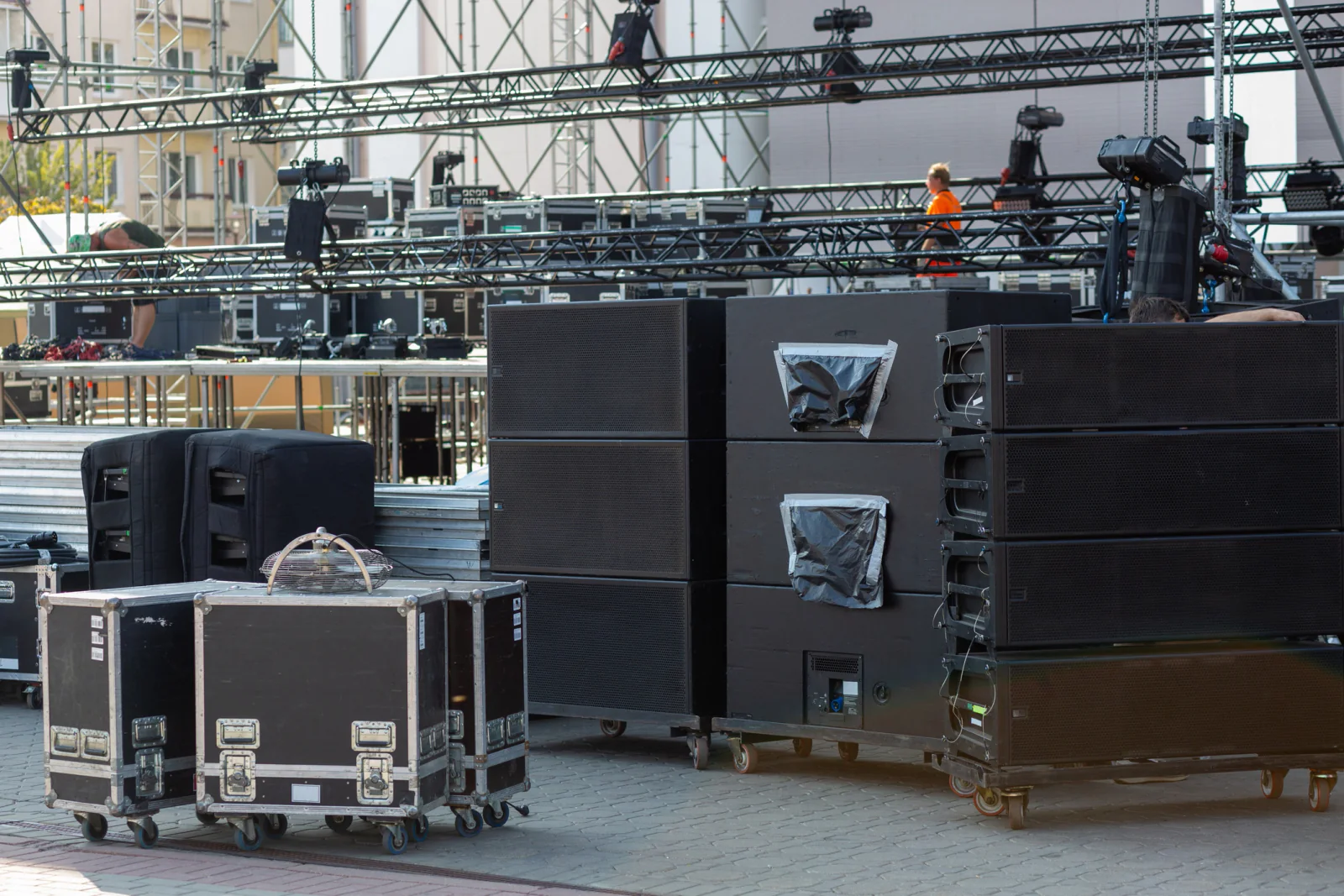 Music festival operations team using laptops, tablets, and support displays to manage staffing and event logistics